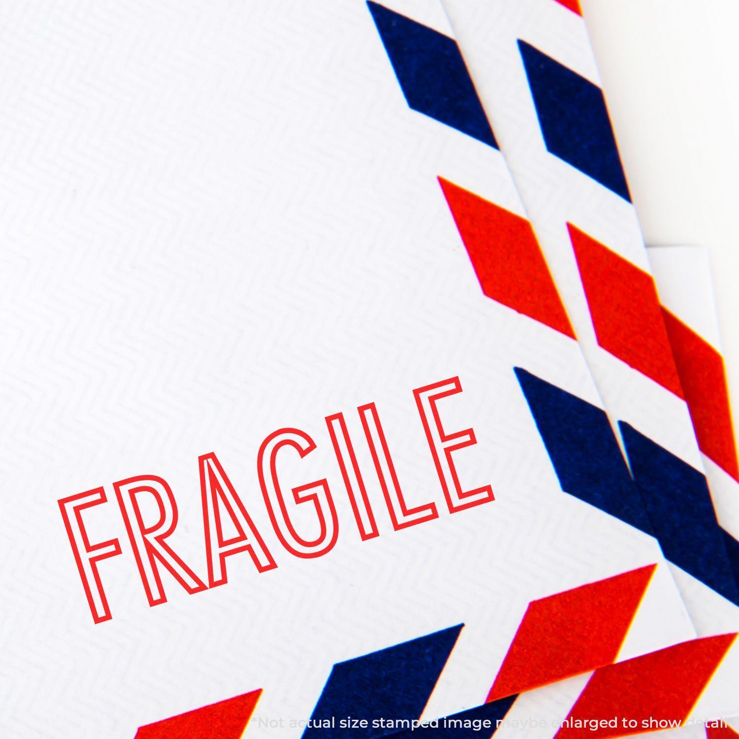 Close-up of a FRAGILE shipping label on white packaging with red and blue design, warning handlers to be careful.