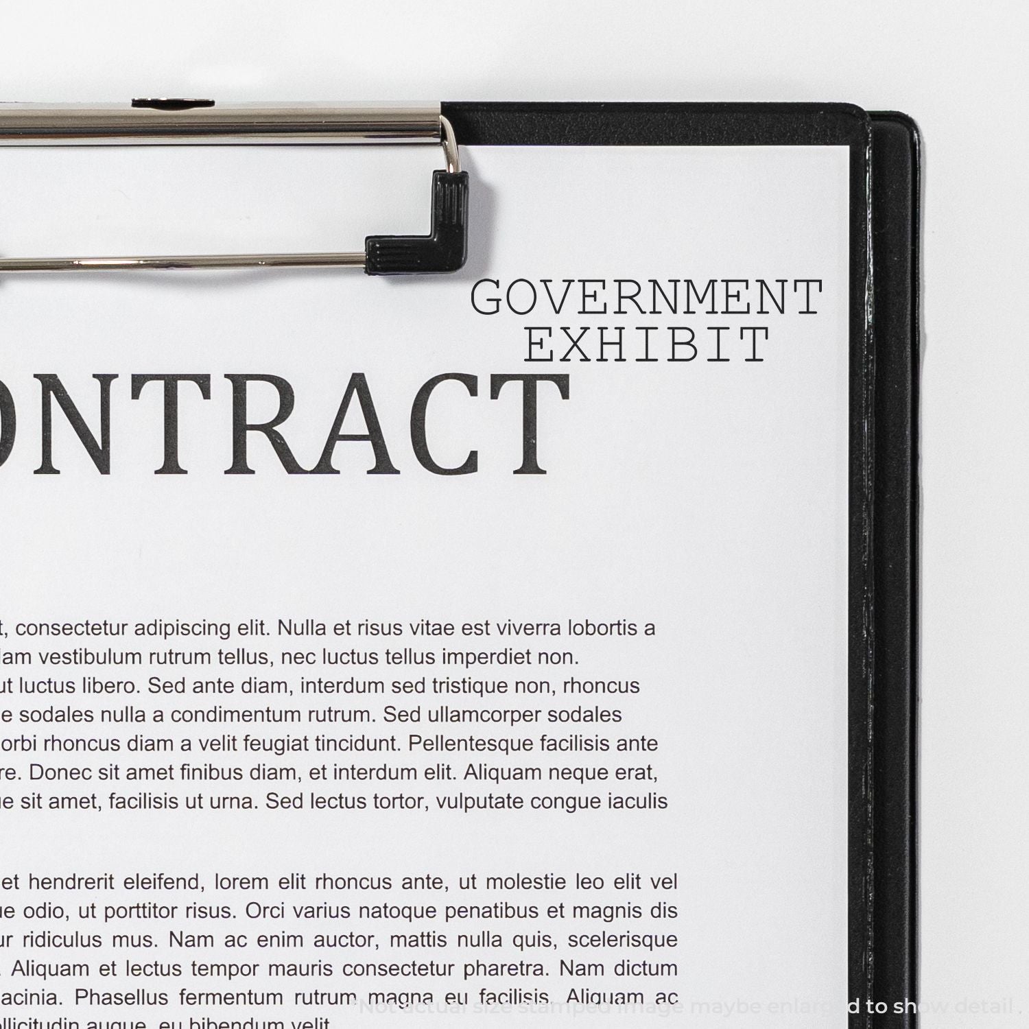 Close-up of a government exhibit contract document clipped to a clipboard.