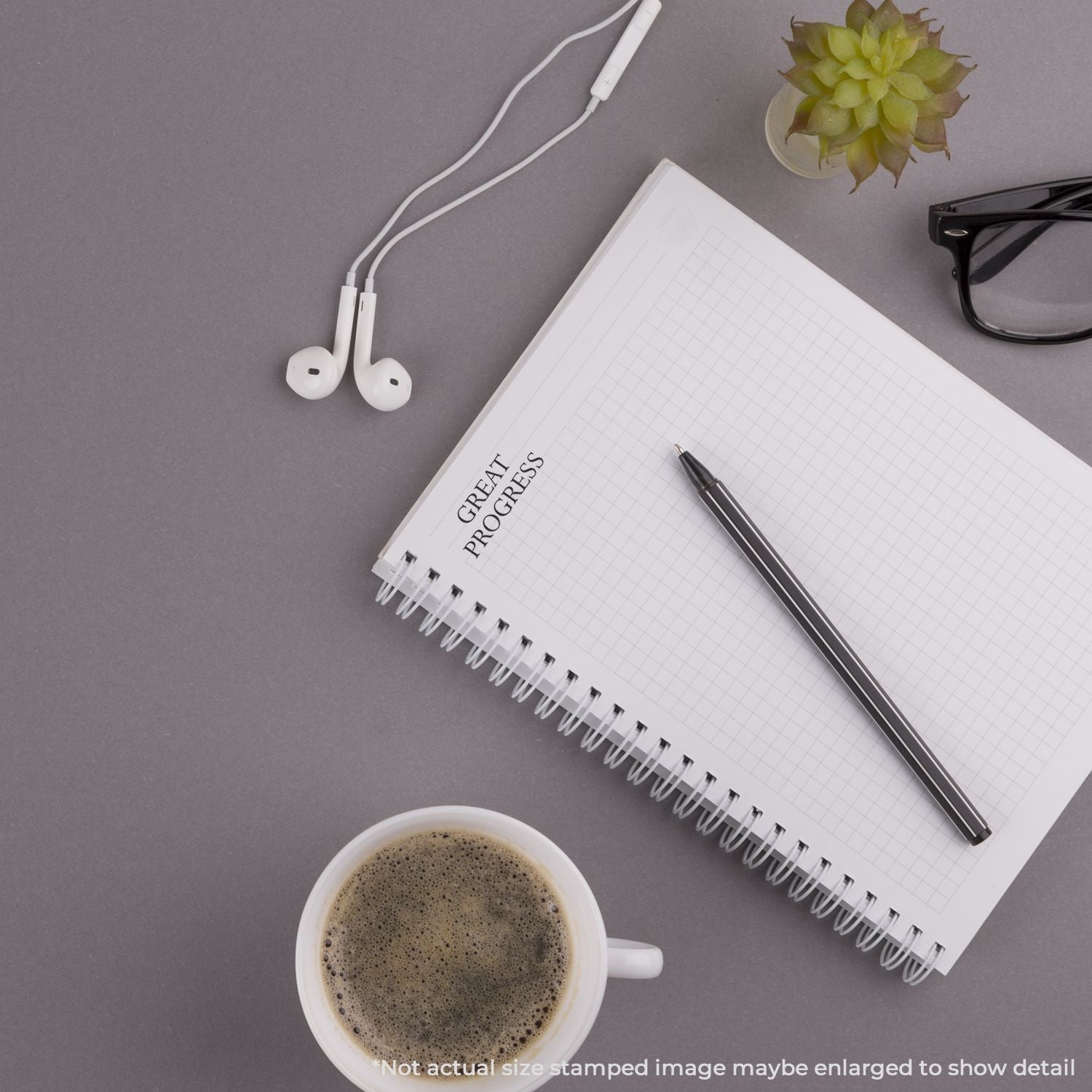 Top view notebook labeled Great Projects with pen, coffee and earbudswork planning and productivity desk setup