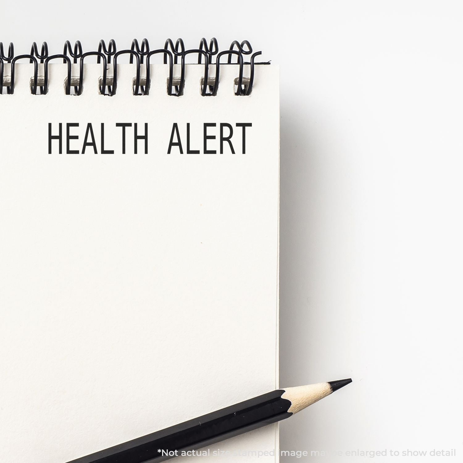 Health Alert on white paper with binder clips and pencil, promoting health awareness and preventive care.