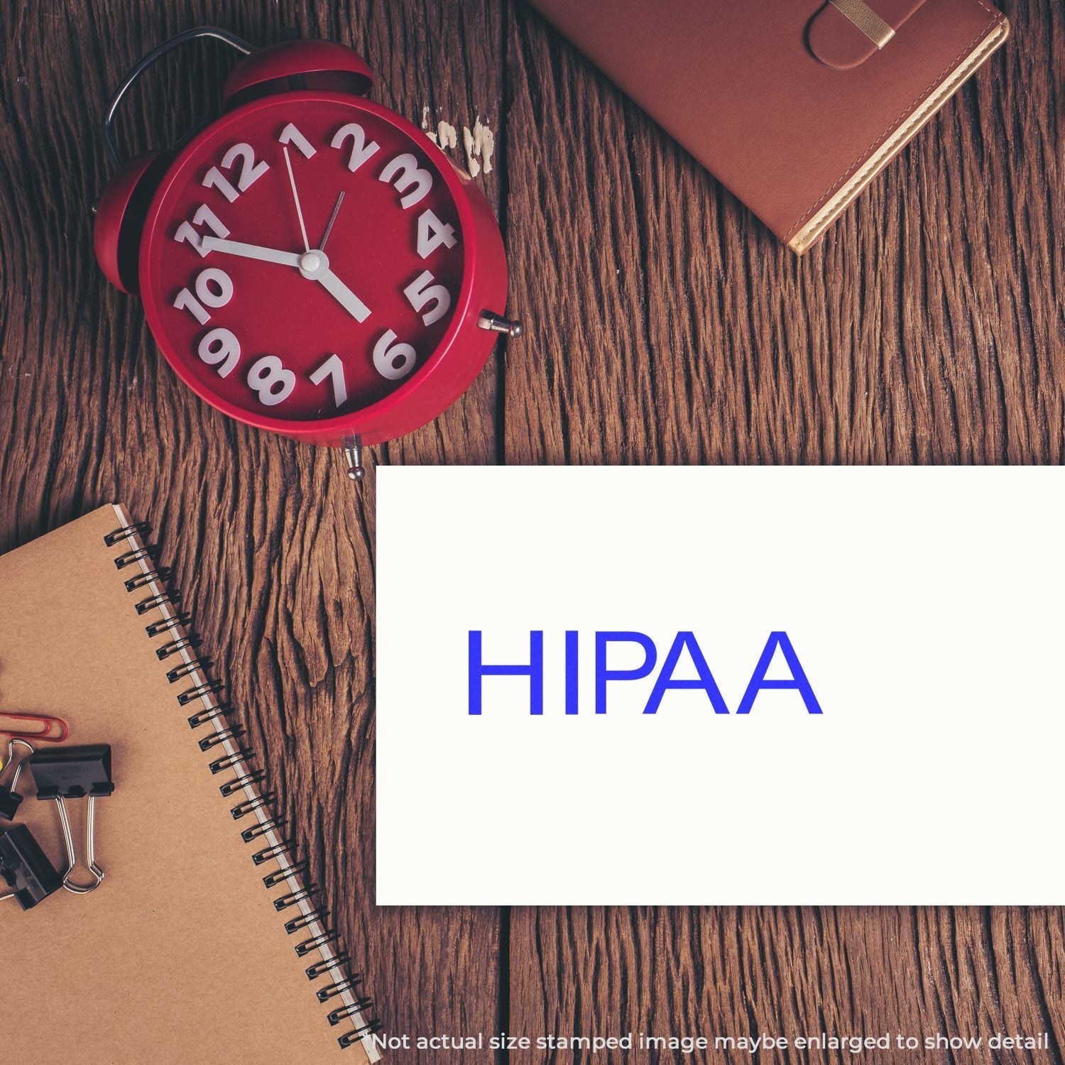 Alarm clock and notebook on desk with HIPAA text, representing healthcare compliance training and privacy deadline reminder.