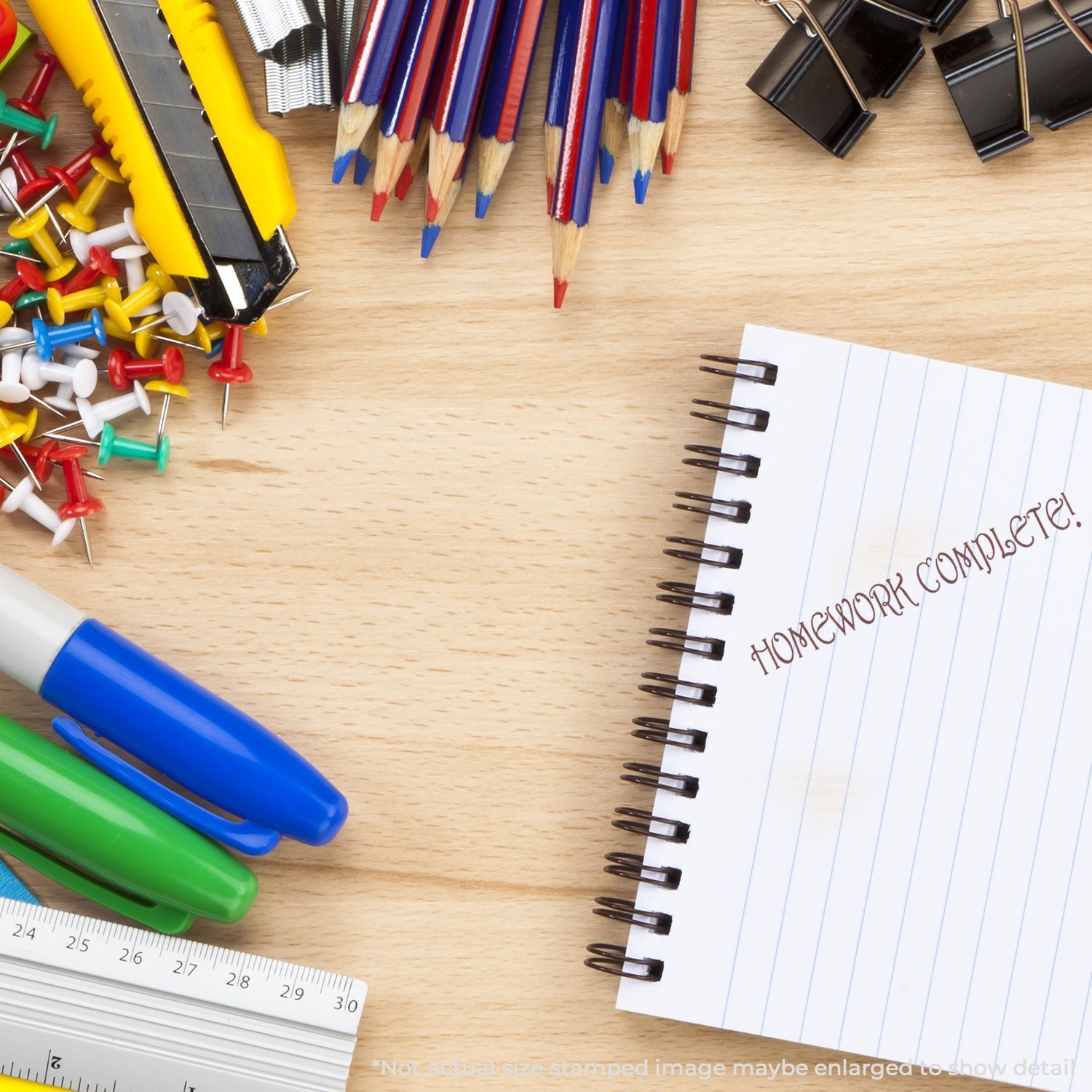 Homework and creative writing toolscolored pencils, markers, eraser, and an open notebook on a wooden desk.