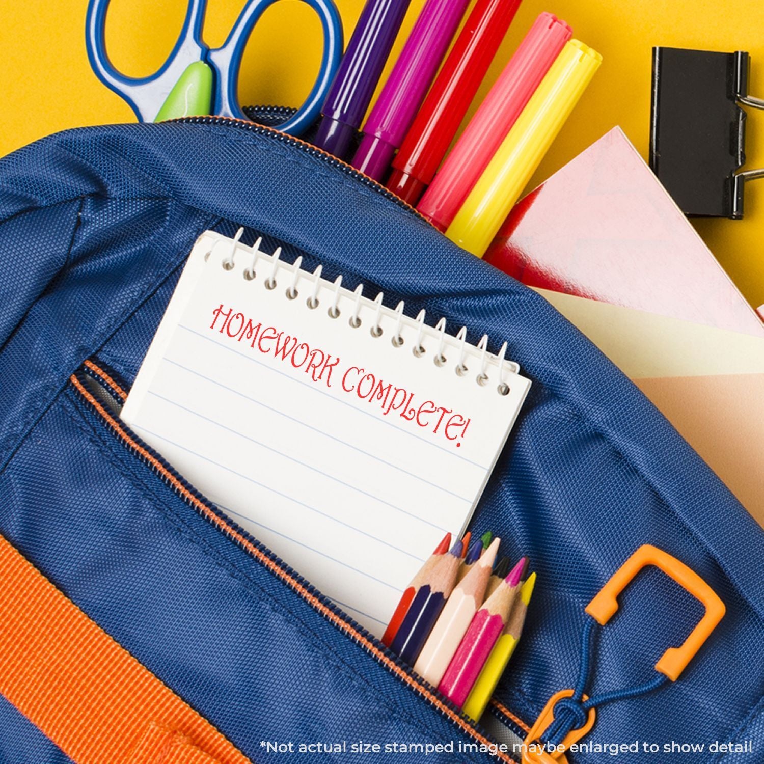 Blue pencil case with HOMEWORK COMPLETE! notepad and colored pencils, showcasing organized school supplies for homework.