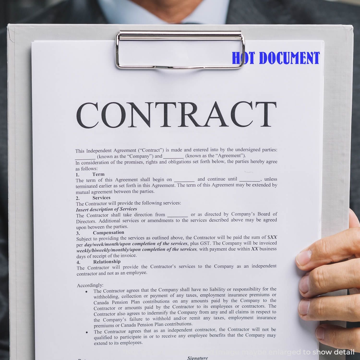 Hand holding a clipboard with an Independent Agreement contract document for business services, terms, and contractor payment details.
