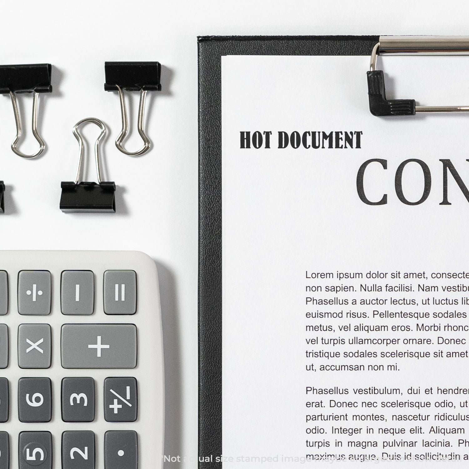 Office desk with calculator, binder clips, and hot document paperwork in a clipboard, business and office organization concept.