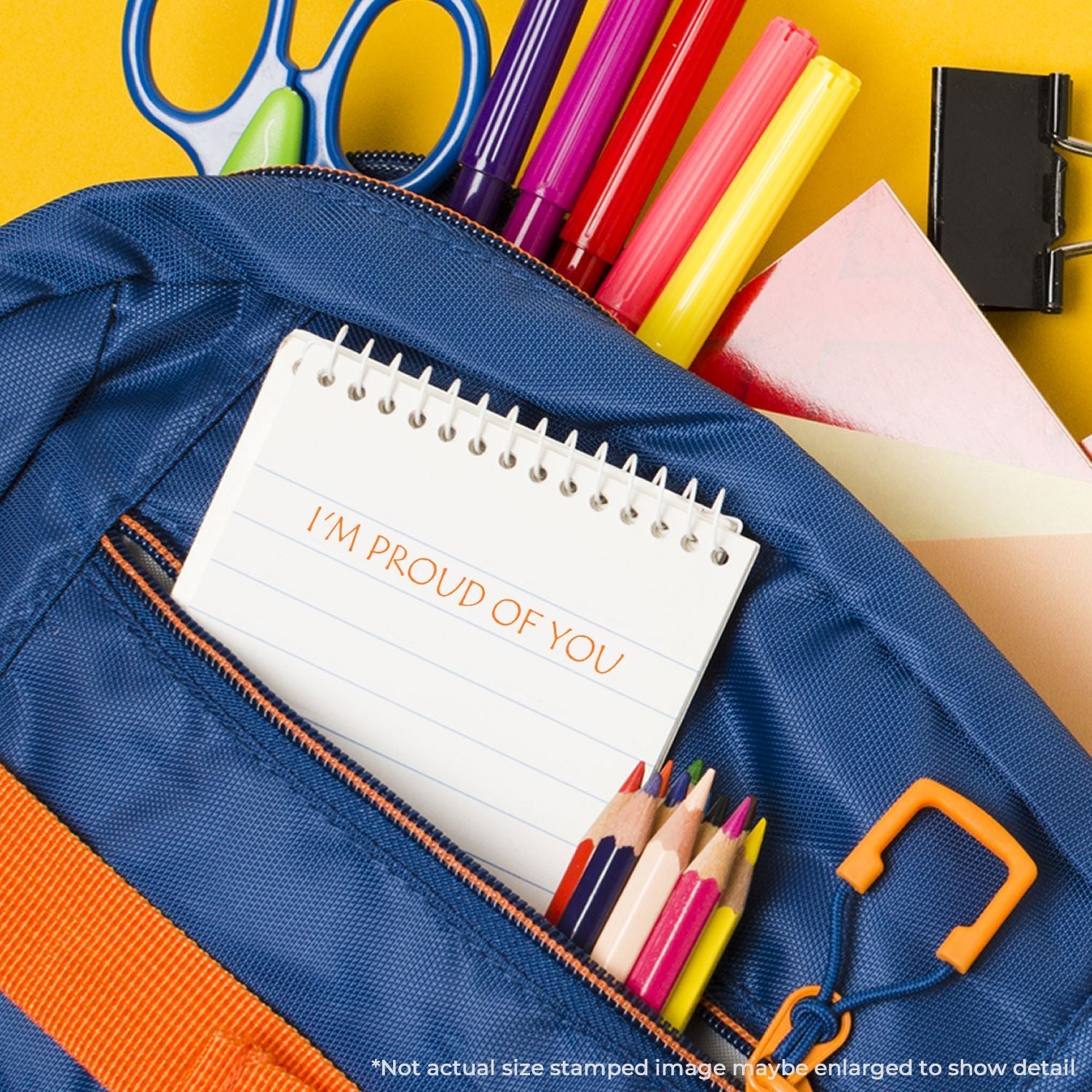 Back-to-school stationery: blue pencil pouch with Im proud of you notebook, colored pencils, markers, and scissors.