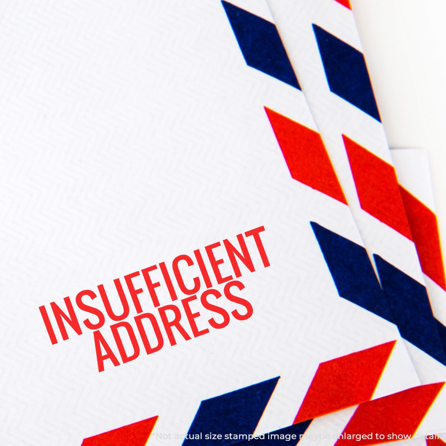 Insufficient address stamped on a red, white, and blue airmail envelope returned by the postal service
