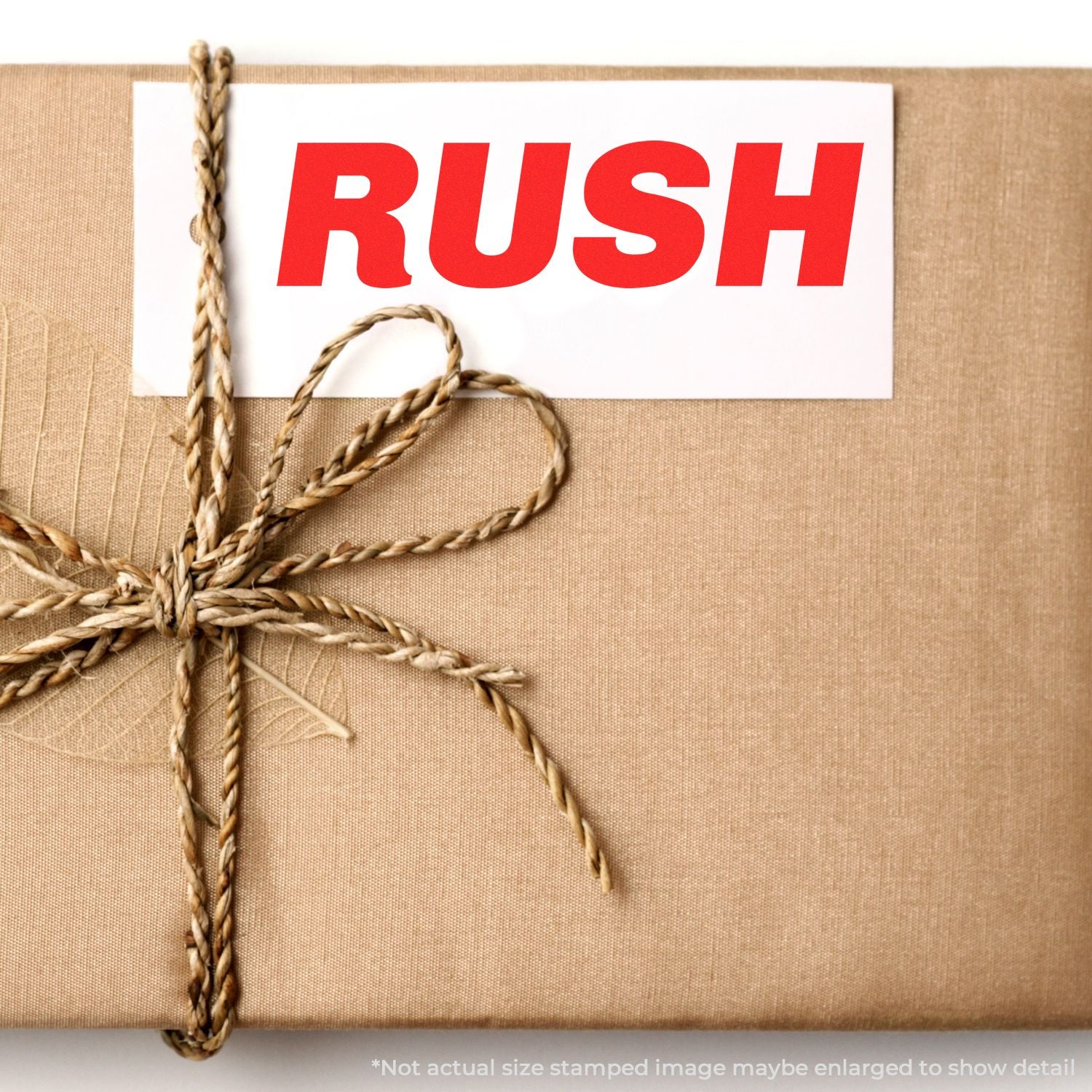 Rush delivery gift wrapped package with twine and bold red RUSH label on brown kraft paper