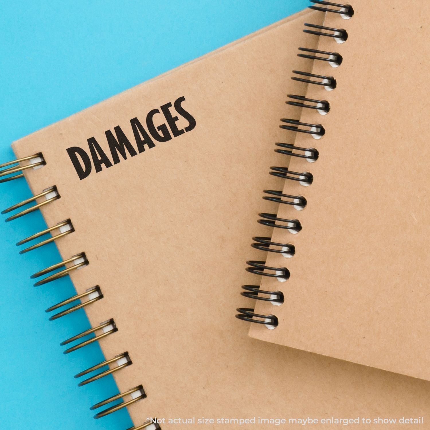 Close-up of spiral notebooks labeled DAMAGES on a blue background, representing legal claims or financial compensation.