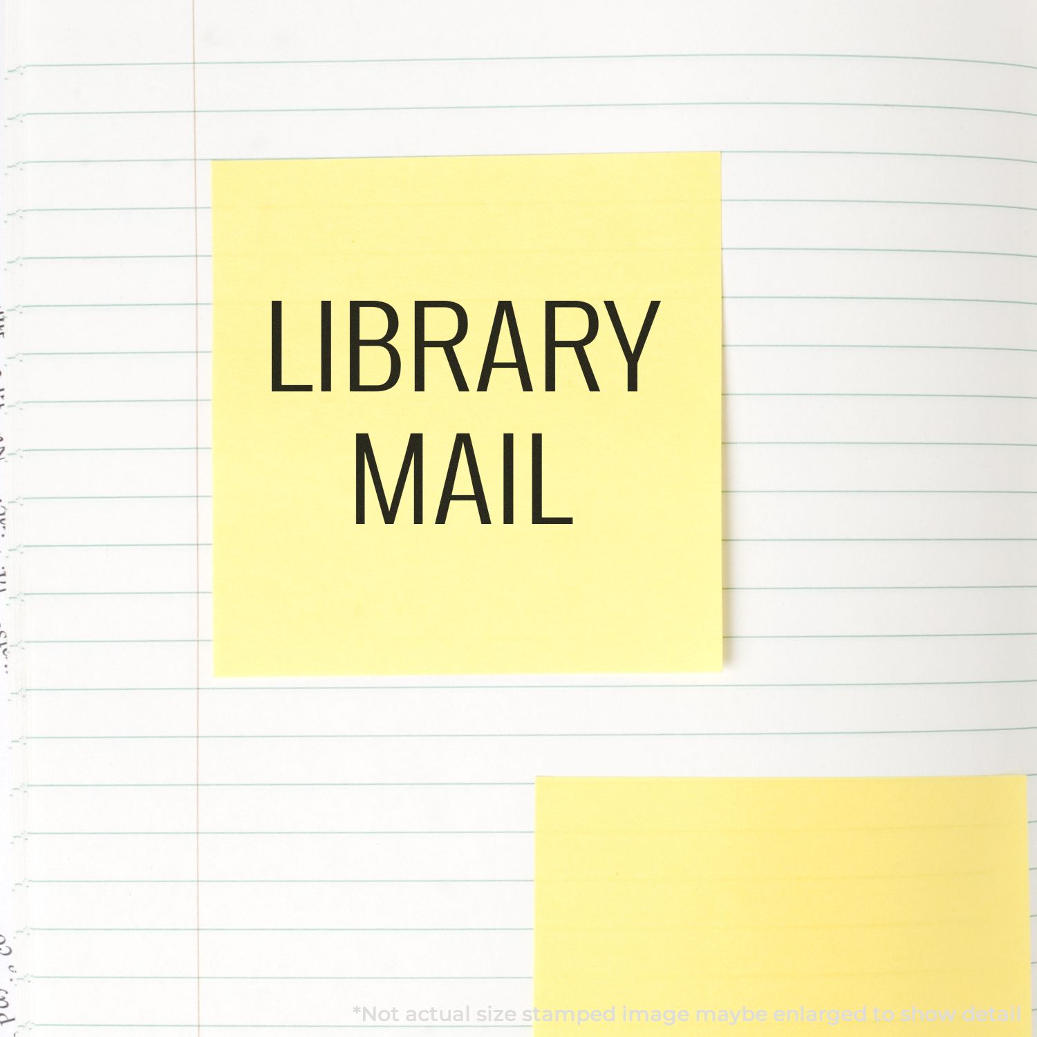 Yellow sticky note labeled LIBRARY MAIL on lined notebook paper, office stationery background.