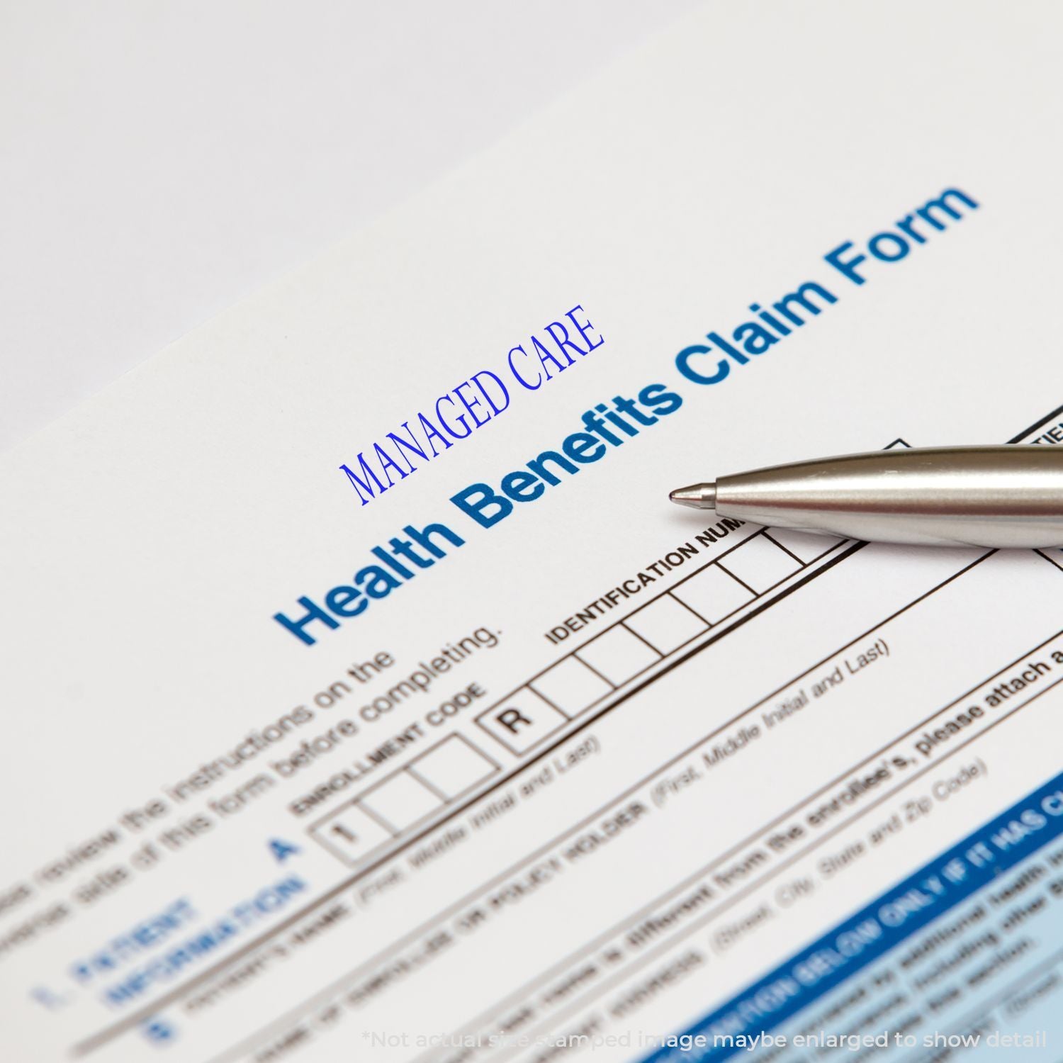 Health benefits claim form with pen, managed care insurance paperwork close-up.