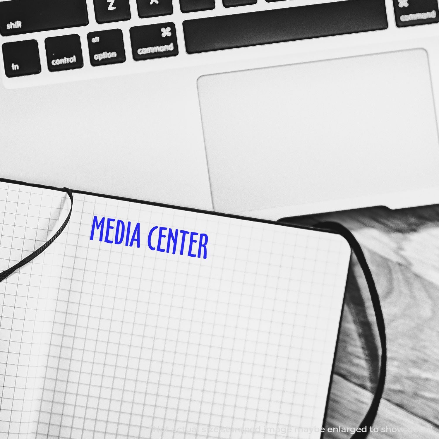 Keyboard and grid notepad labeled MEDIA CENTER, representing media management and content planning.