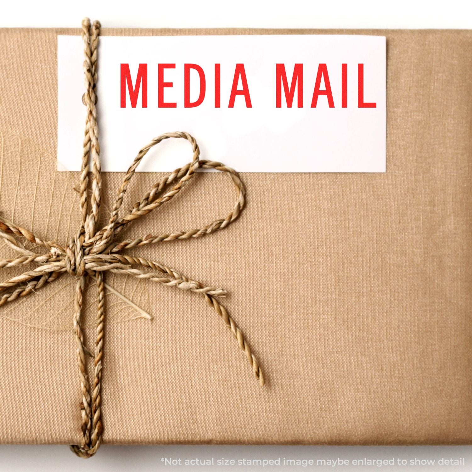Media Mail shipping label on a tied cardboard package, highlighting USPS Media Mail service for shipping books, CDs, DVDs, and media.