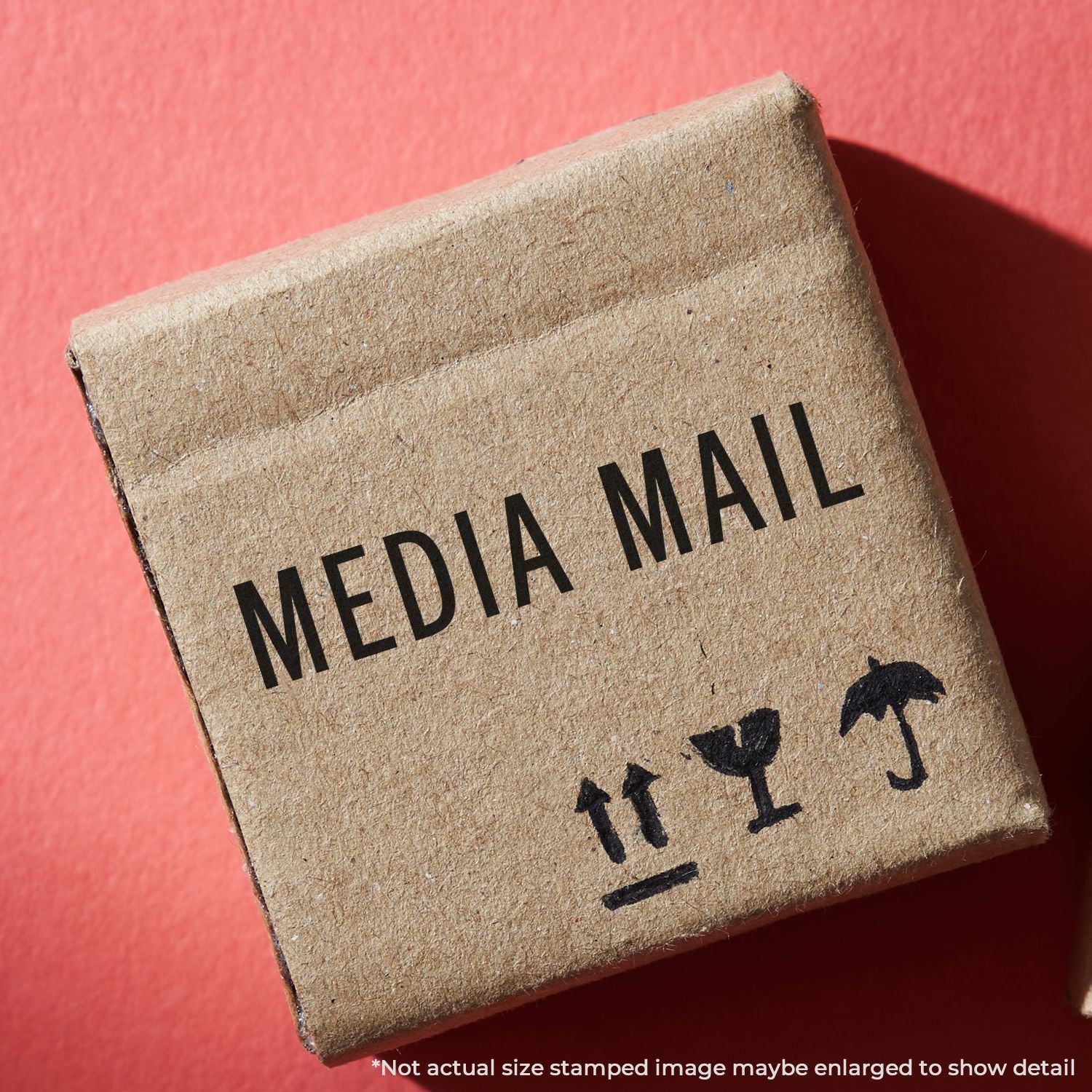 Close-up of a Media Mail shipping box label on brown parcel, showing USPS Media Mail postage for media items shipping service delivery.