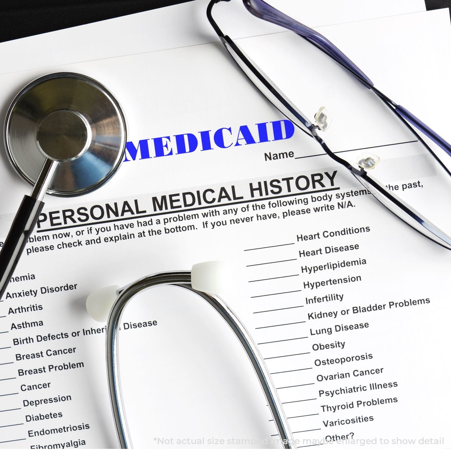 Stethoscope and eyeglasses on Medicaid personal medical history form with health condition checklist.