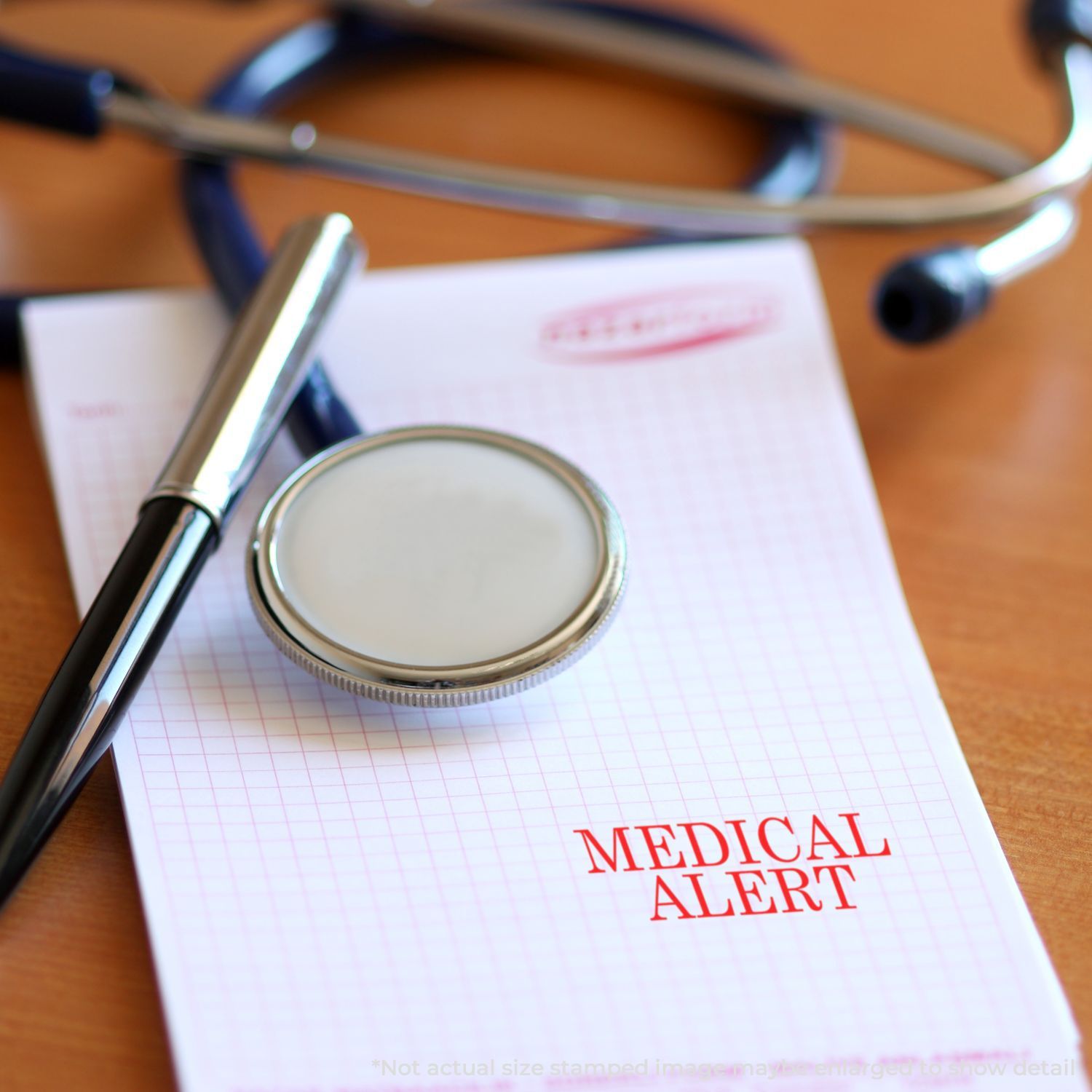 Medical alert notepad with stethoscope, pen, and magnifying glass on a desk.
