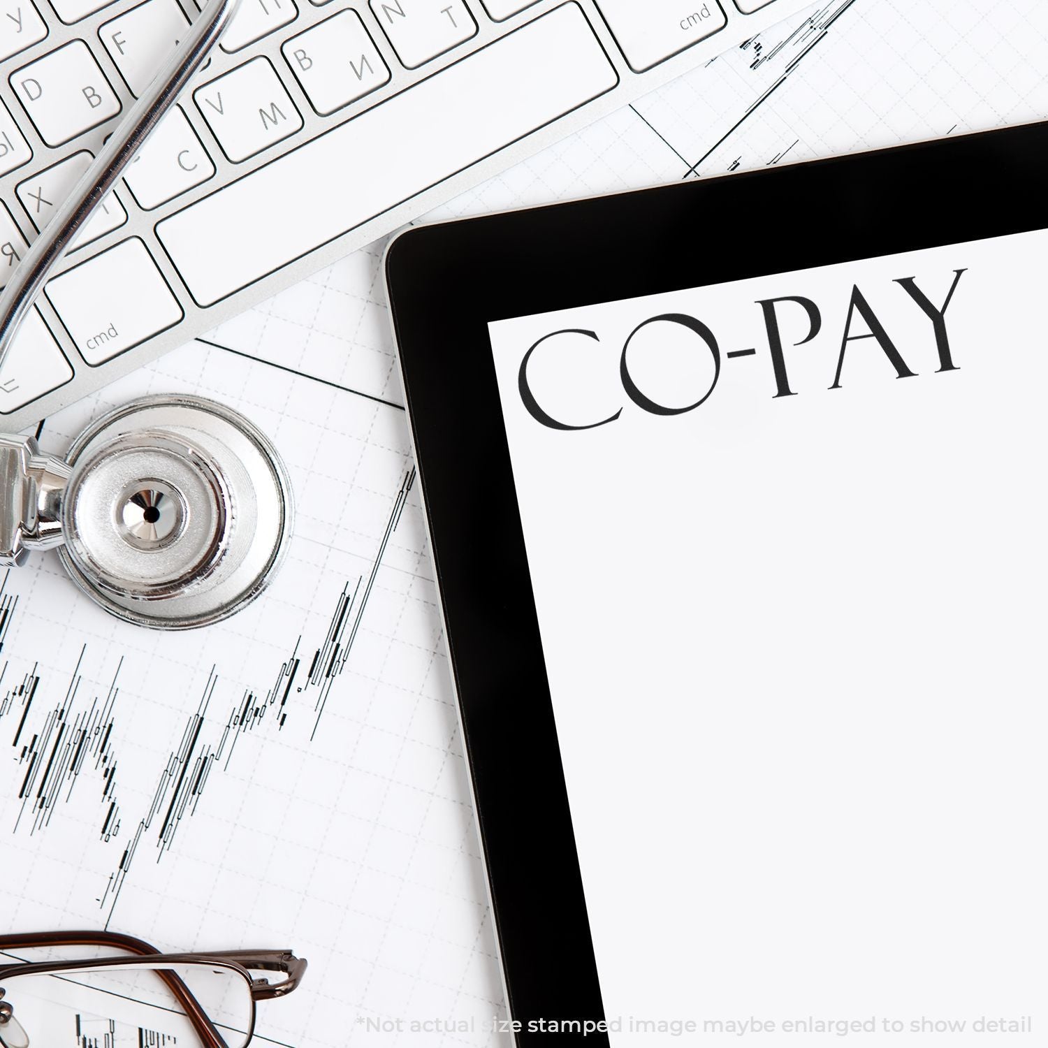 Tablet displaying CO-PAY on a desk with keyboard, stethoscope, eyeglasses, and financial chart, representing healthcare costs and medical billing.