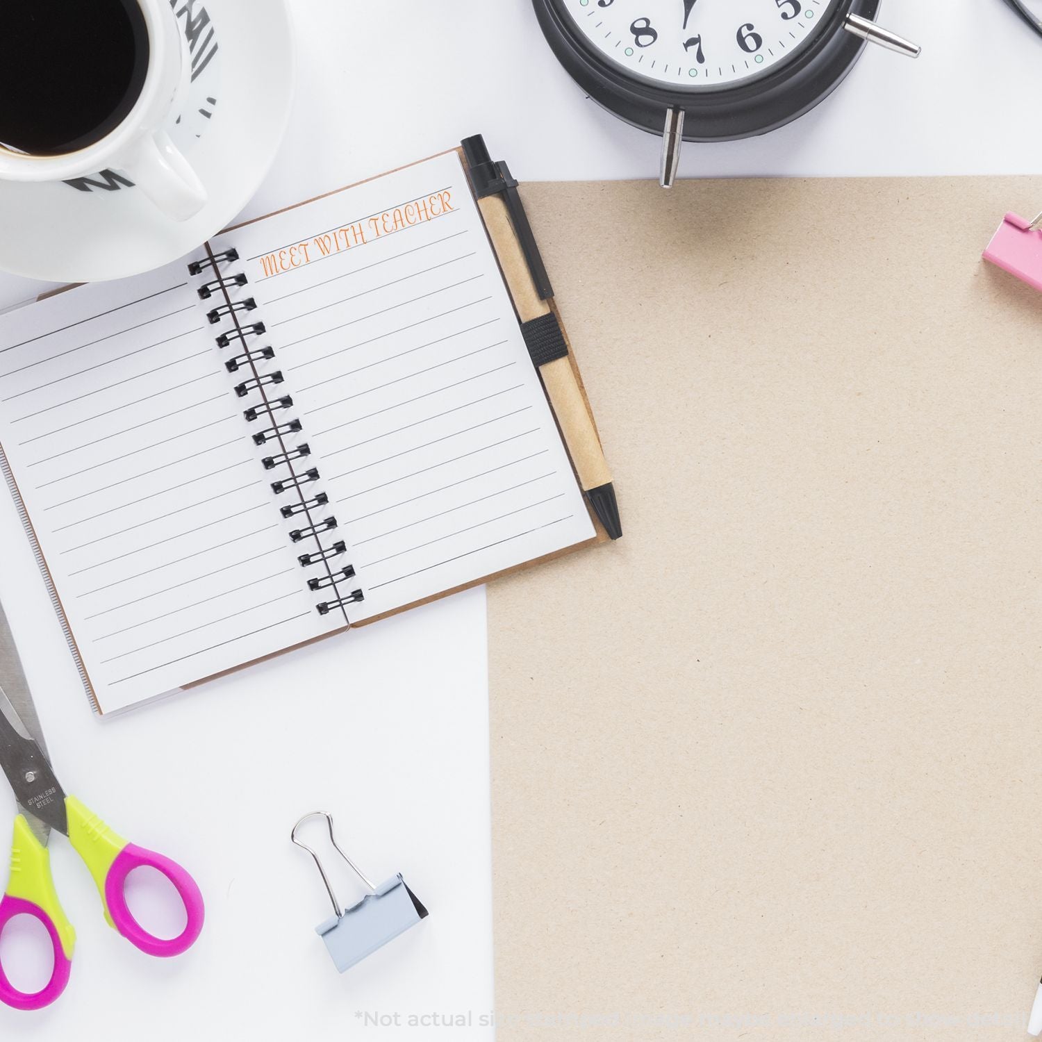 Top view of teacher meeting planner notebook with coffee, alarm clock, scissors, and blank workspace on a desk