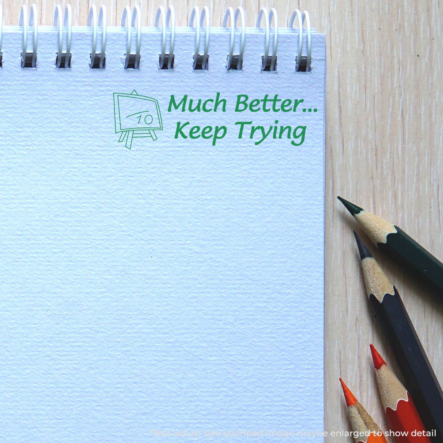 Motivational learning message on wall: Much Better Keep Trying beside sharpened pencils for student encouragement and school success.