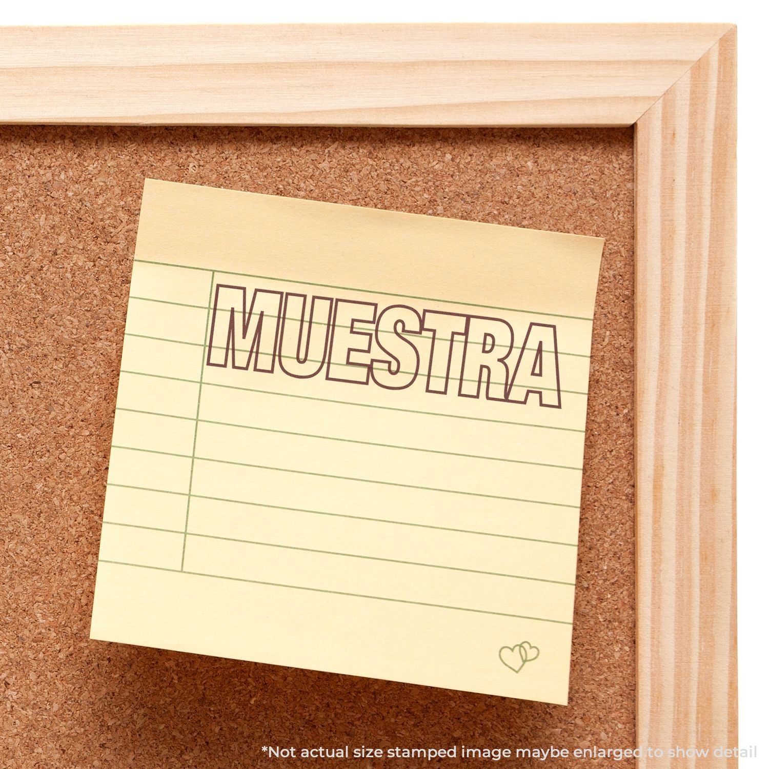 Sticky note with MUESTRA sample stamp on a corkboard in a wooden frame, close-up Spanish label image