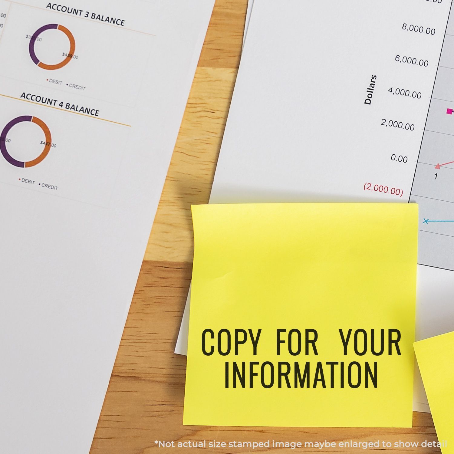 Yellow sticky note reading Copy for Your Information on financial reports with balance charts on a wooden desk.