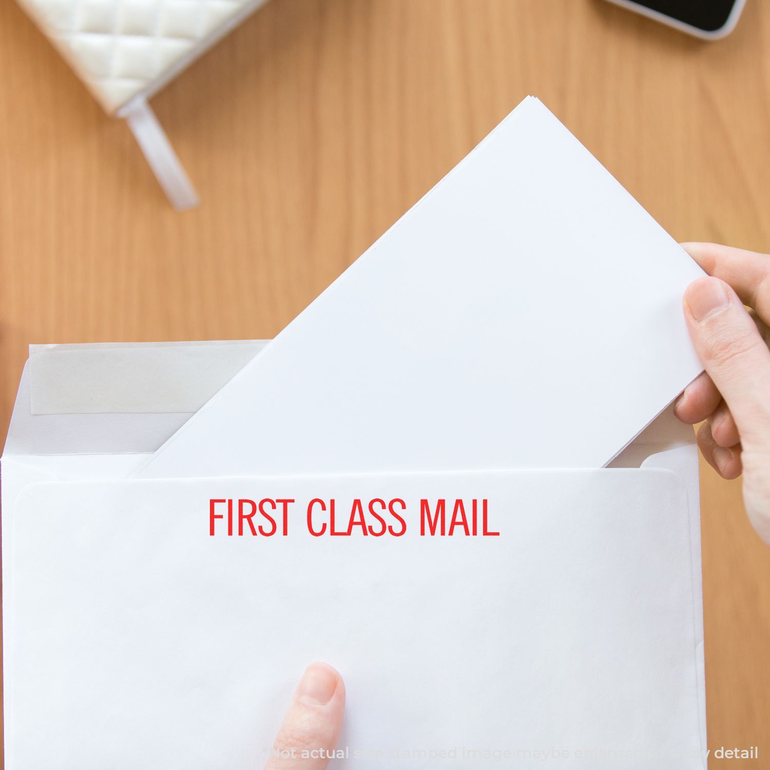 Hand inserting letter into First Class Mail mailbox slot, promoting USPS-style shipping and reliable document delivery services.