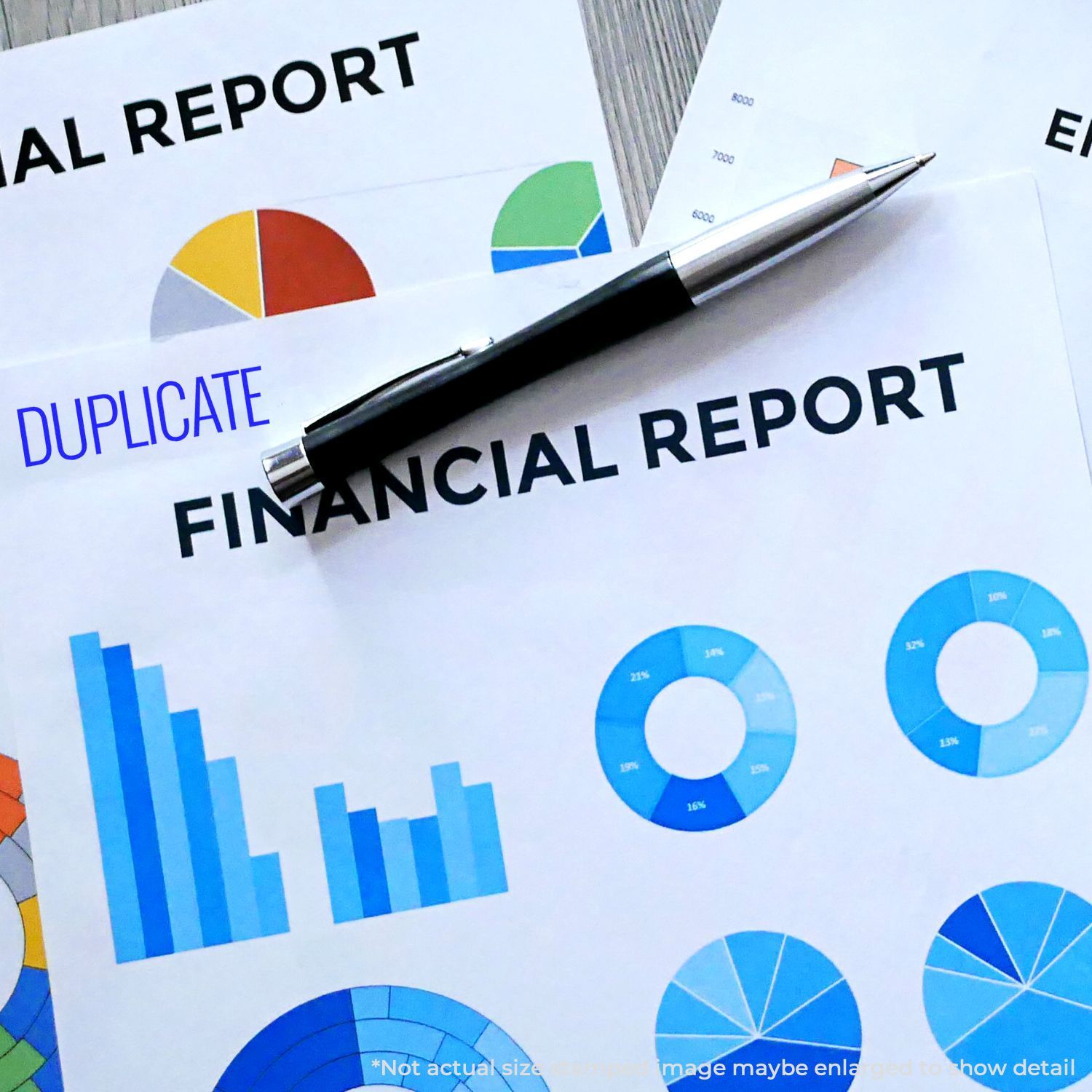 Pen over duplicate financial report with business charts and pie graphs, illustrating data analysis and reporting.