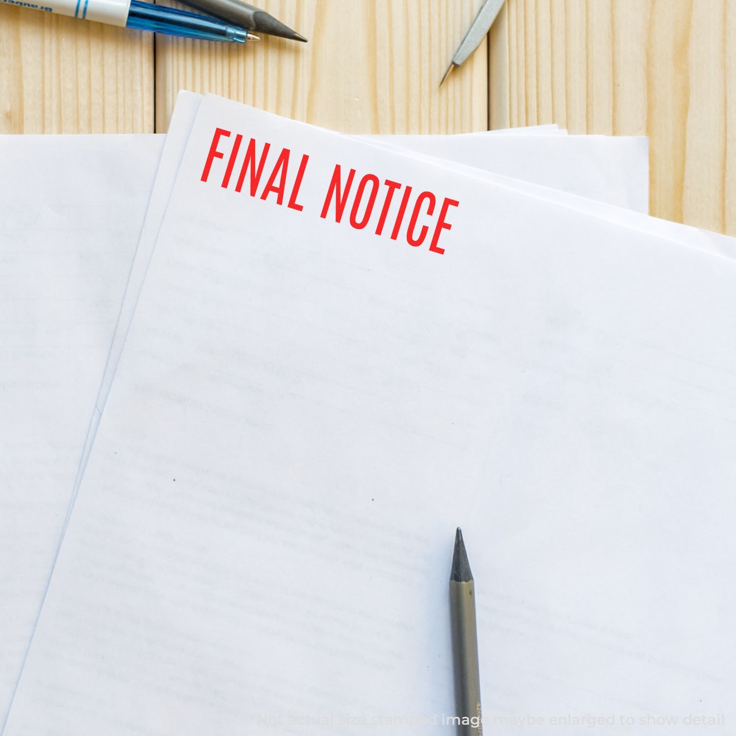 Final notice document on desk with pens, showing printed warning text FINAL NOTICE for legal or payment reminders.