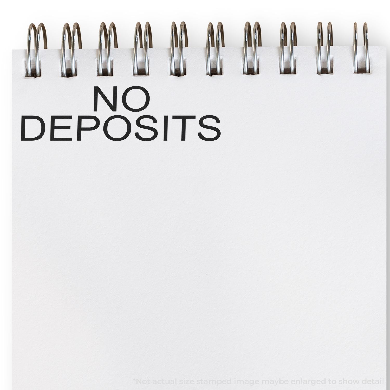 No deposits sign with binder clips on white background, indicating a deposit-free policy for bookings and rentals.