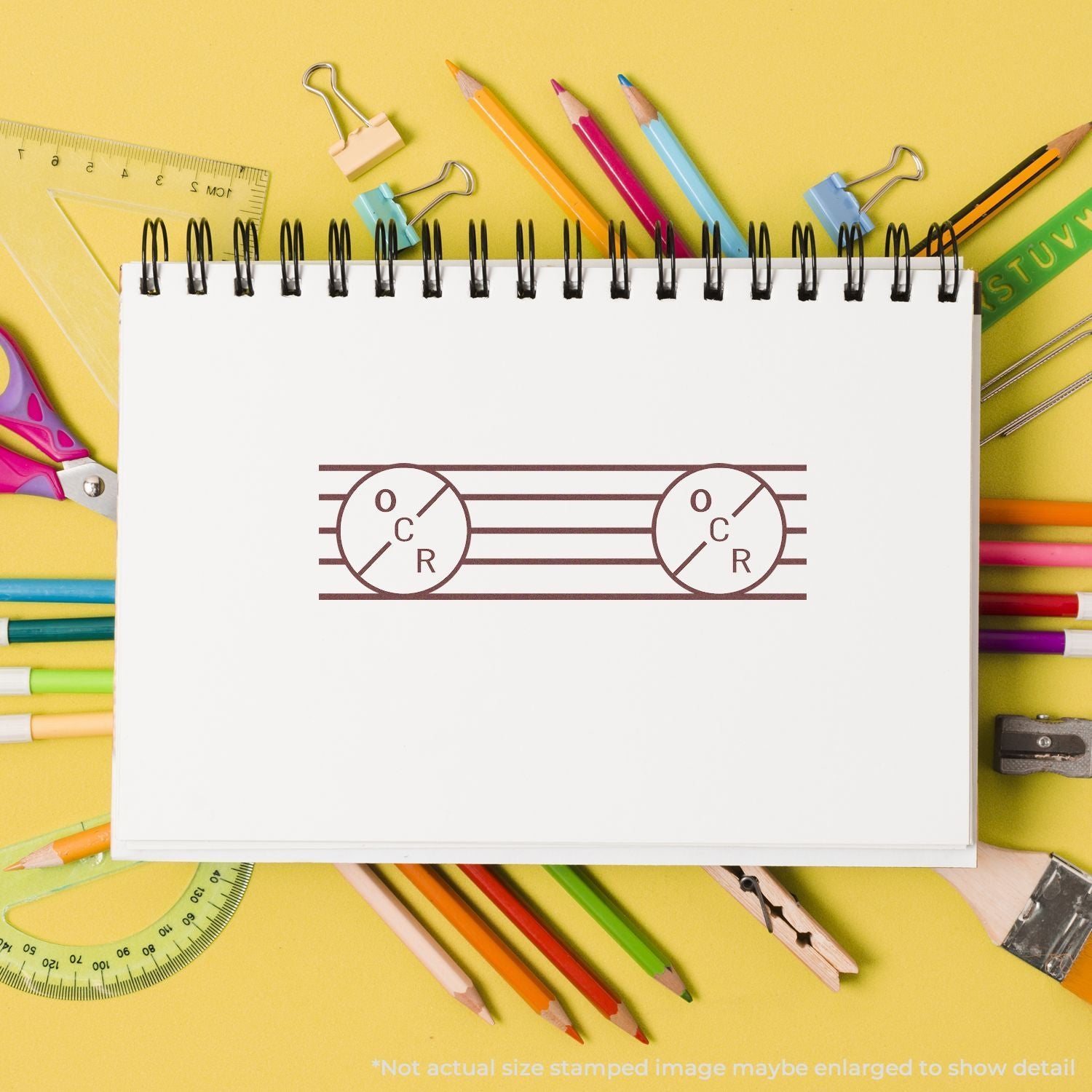 Biology lesson concept: notebook shows DNA double helix diagram with pencils, crayons, ruler, and paper clips on yellow desk study.