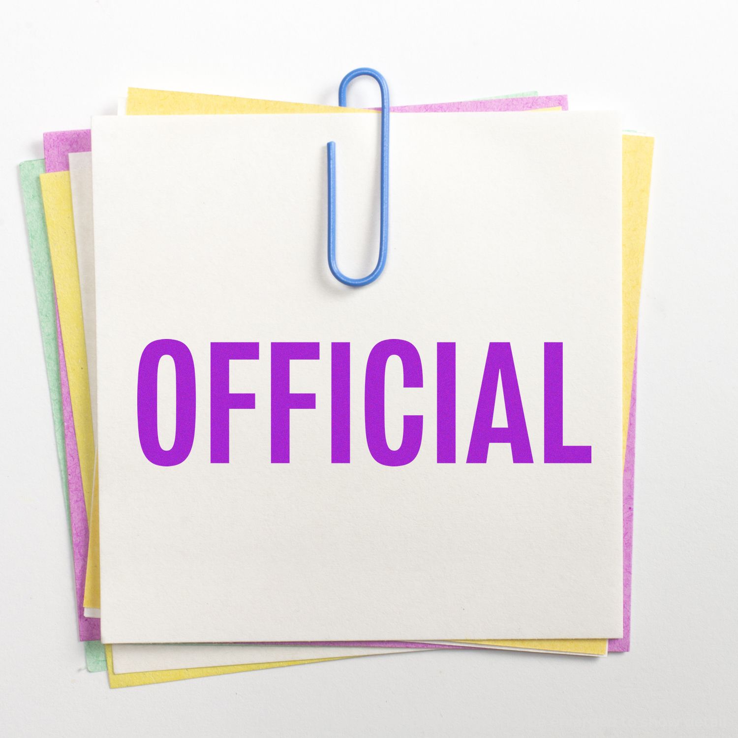 Stacked stationery with blue paper clip and OFFICIAL text label, symbolizing verified paperwork and official documents.