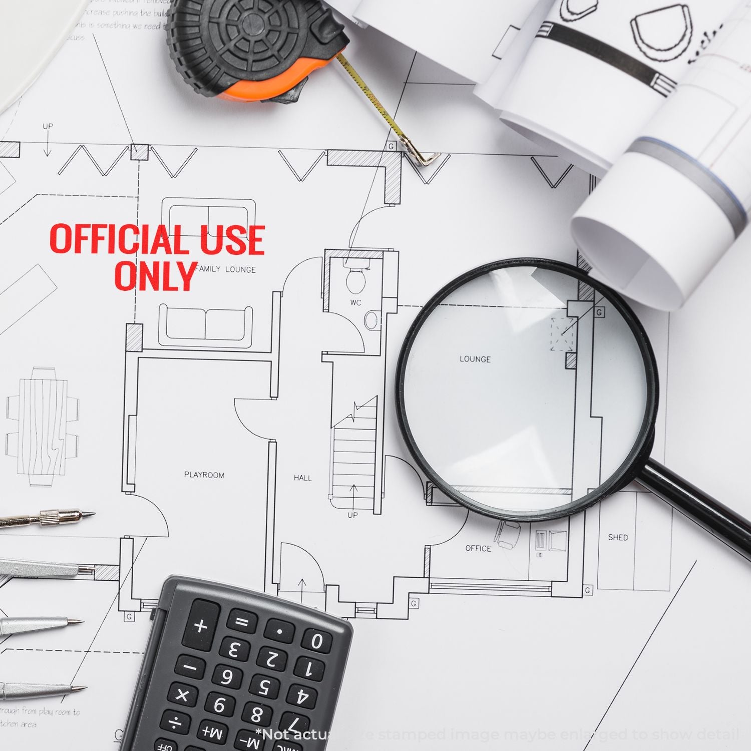 Architectural blueprint floor plan marked Official Use Only with calculator and magnifying glass for property planning review inspection