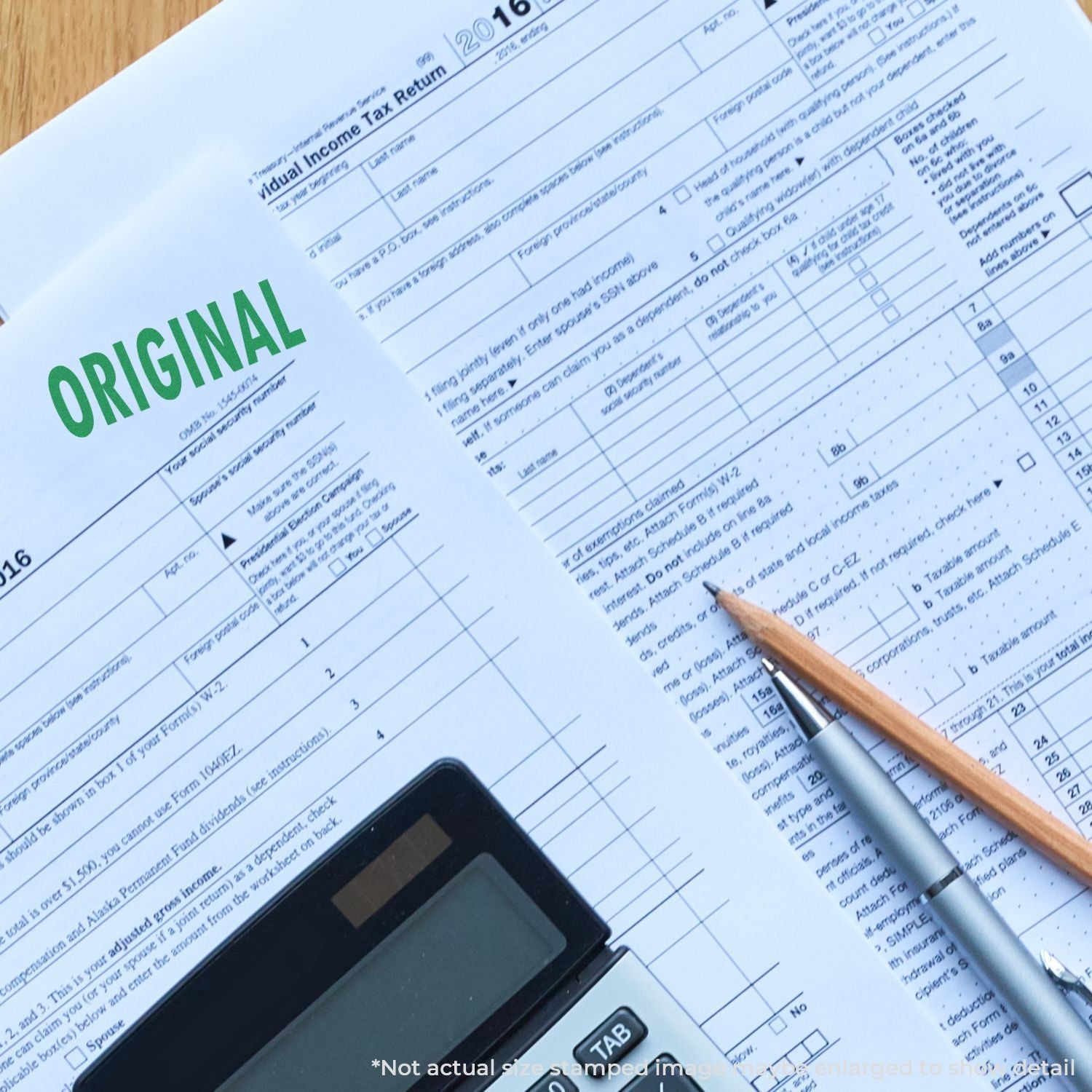 Tax return worksheet labeled ORIGINAL with pen and calculator, illustrating income tax filing and IRS form preparation.