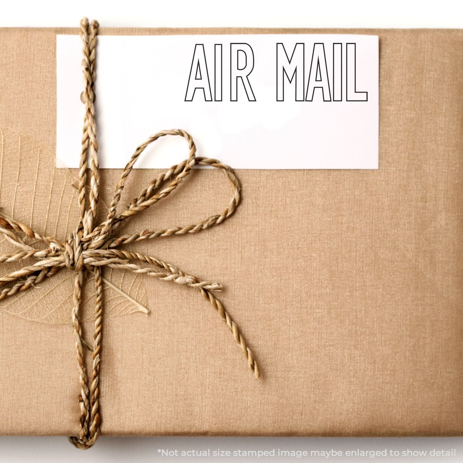 Wrapped brown kraft paper parcel with twine and air mail tag, vintage-style gift packaging detail