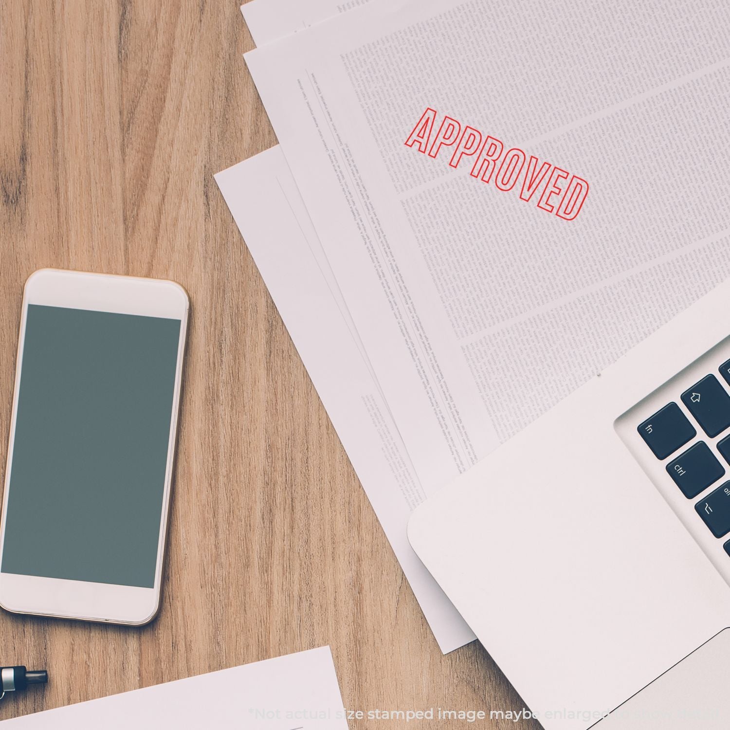 Approved stamp on documents with phone and laptopworkflow signoff, admin paperwork approval and business process