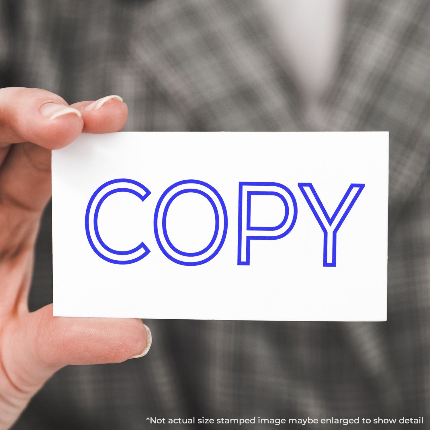 Hand holding a card with blue COPY text, representing copying and print service in office document workflow.
