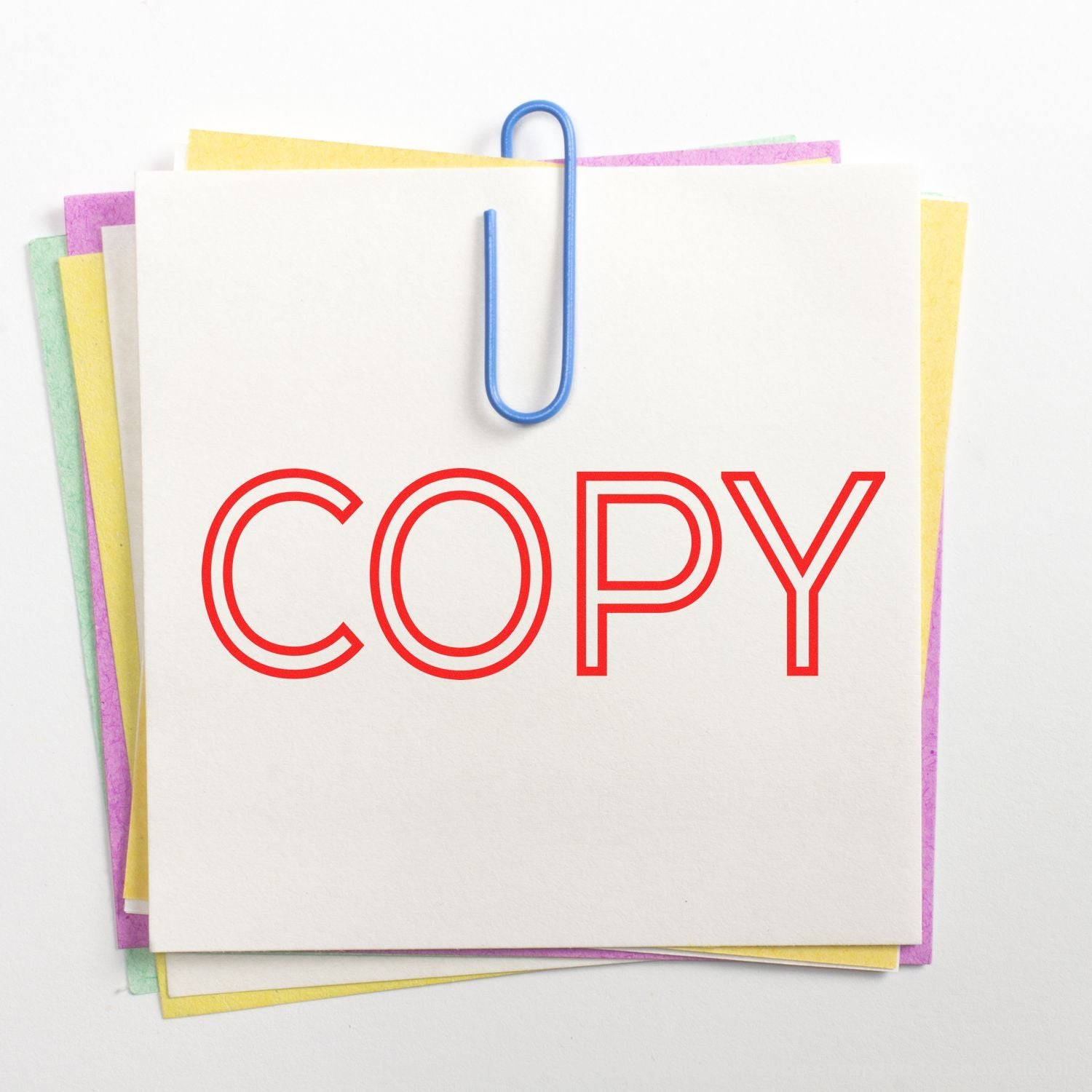 Stack of colorful paper sheets clipped with a blue paperclip and the word COPY in red on a white background.