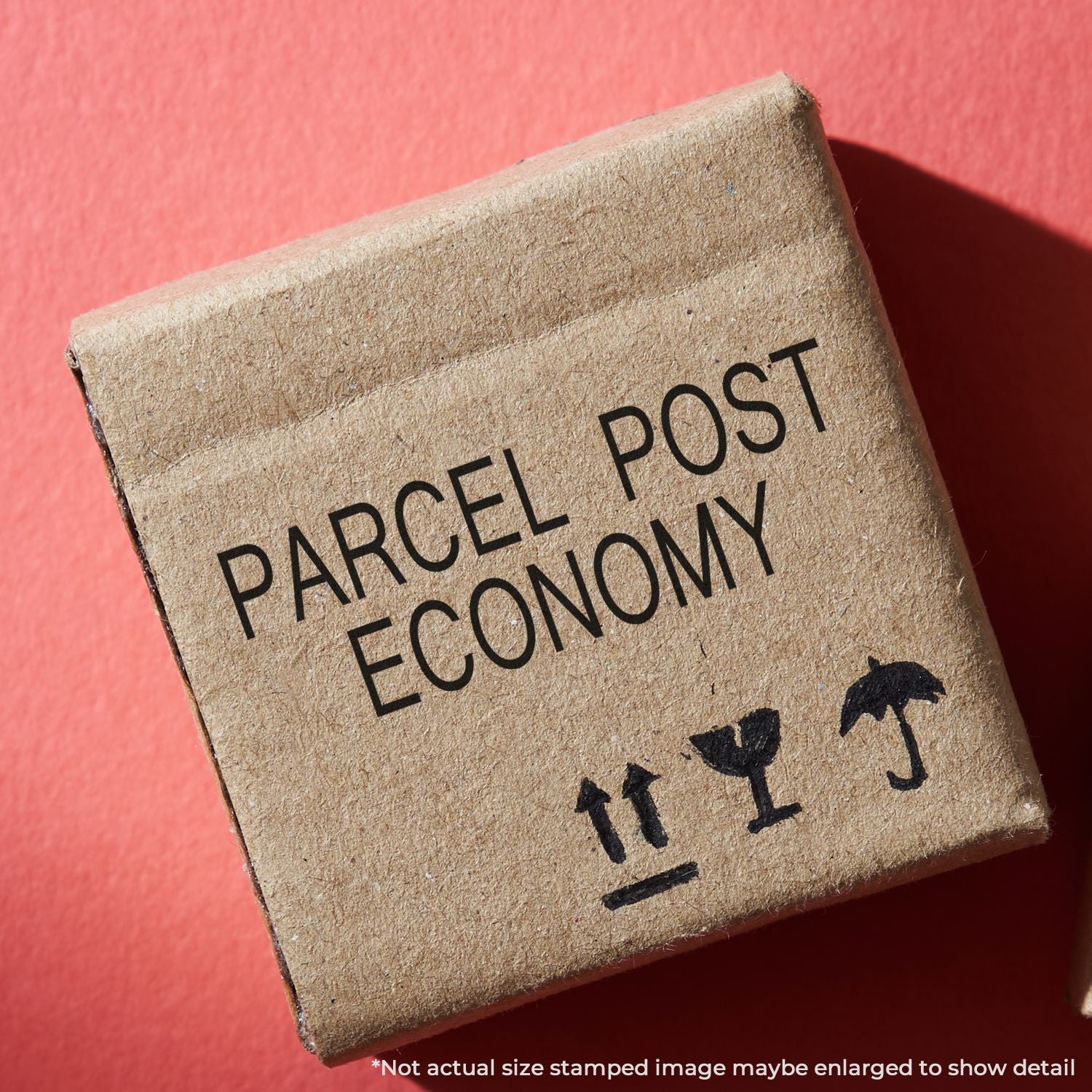 Brown parcel post economy cardboard shipping box with fragile symbols on a red background.