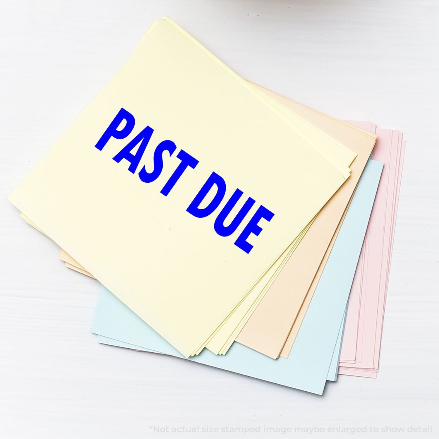 Pasty due notice document on pastel folder stack, symbolizing late payment, overdue bills, and financial reminders