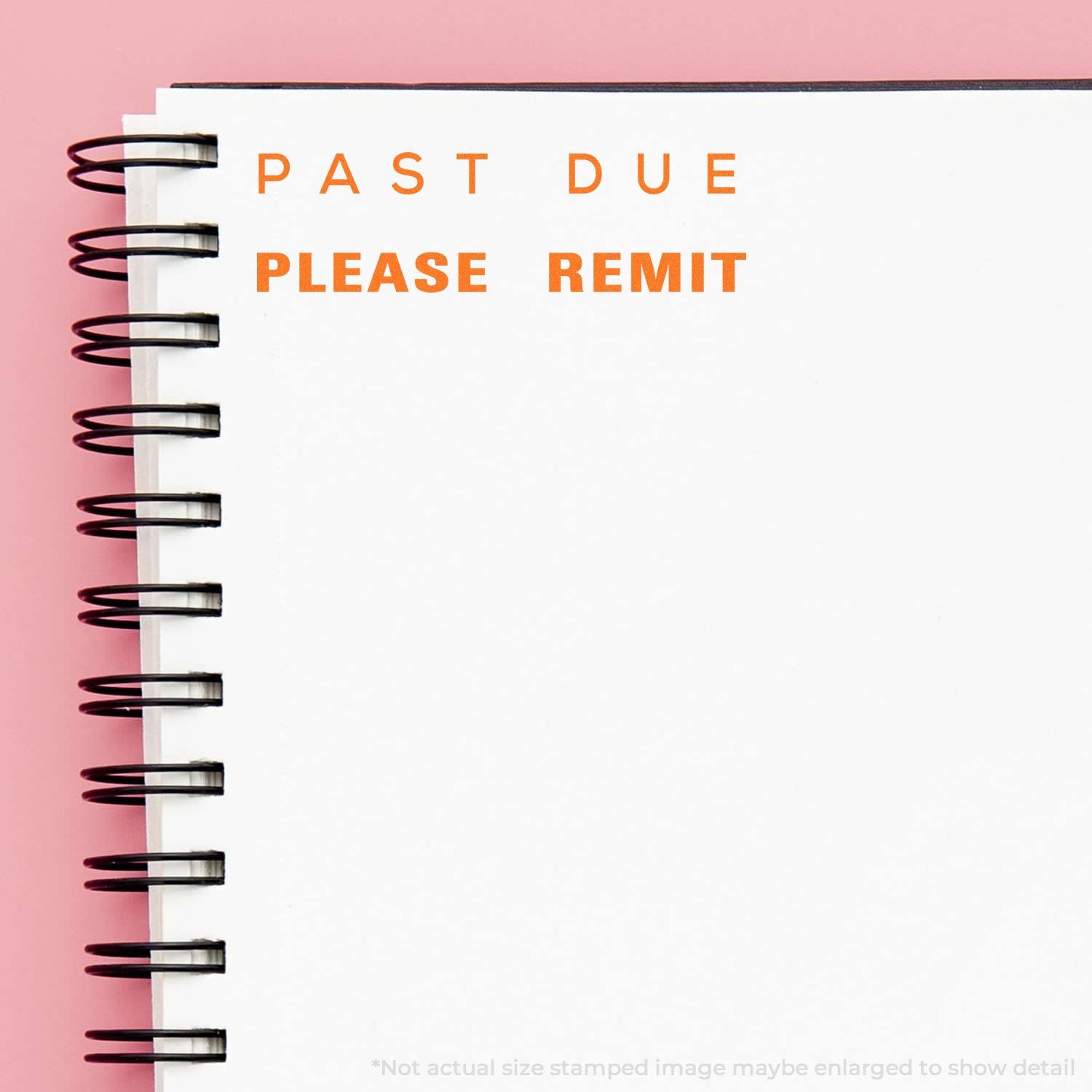 Close-up of a spiral notebook page stamped PAST DUE PLEASE REMIT on a pink background, symbolizing an overdue payment notice.