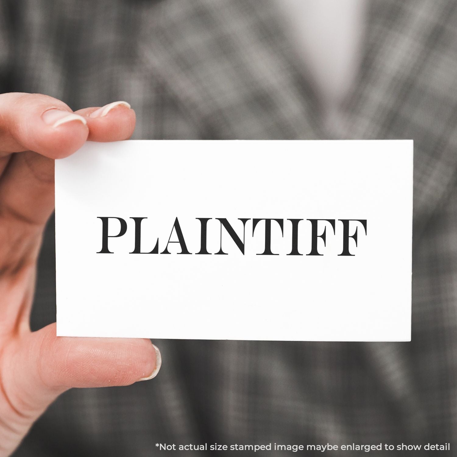 Hand holding a white card stamped 'PLANTIER' for planter and gardening branding on a blurred outdoor background, product label.