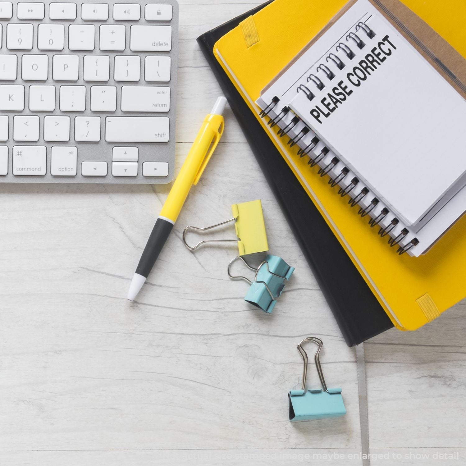 Notebook marked Please Correct with keyboard, pen, and binder clipsediting and proofreading documentation concept