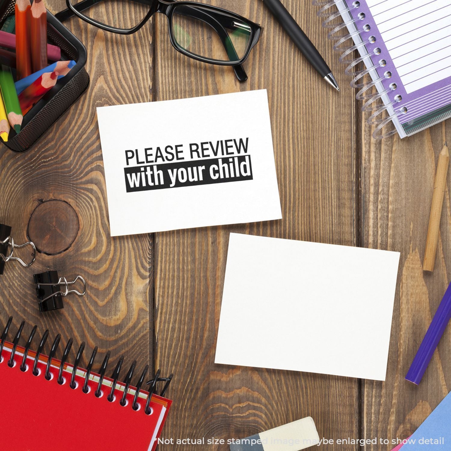 Back-to-school desk with school supplies and note reading Please review with your child on wooden table.