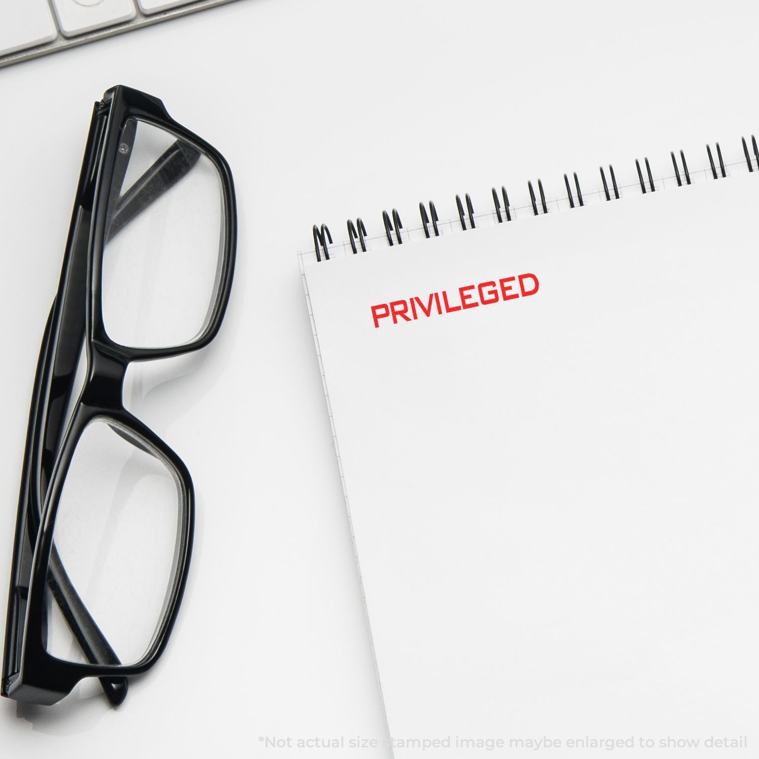 Eyeglasses beside a notebook stamped PRIVILEGED, symbolizing education privilege and advantages in academic success