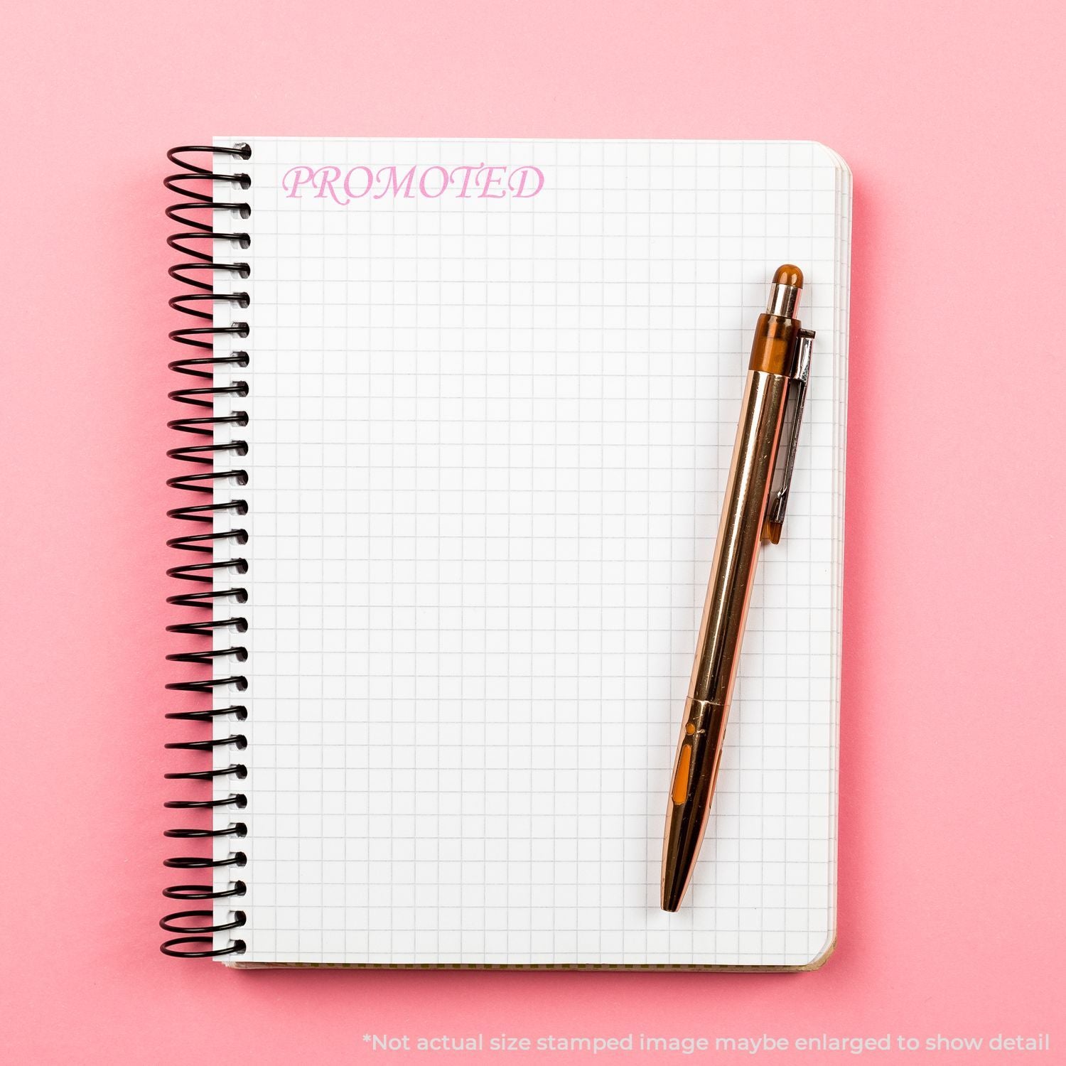 Promoted spiral notebook with pen on pink background, blank grid paper for planning or business notes