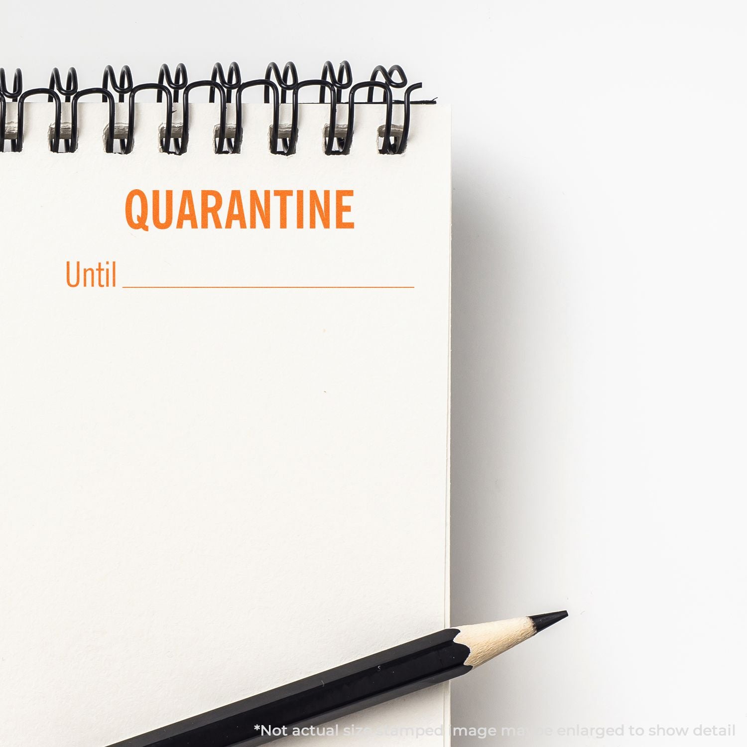 Quarantine reminder notepad with binder clips and pencil showing QUARANTINE and Until for COVID isolation planning