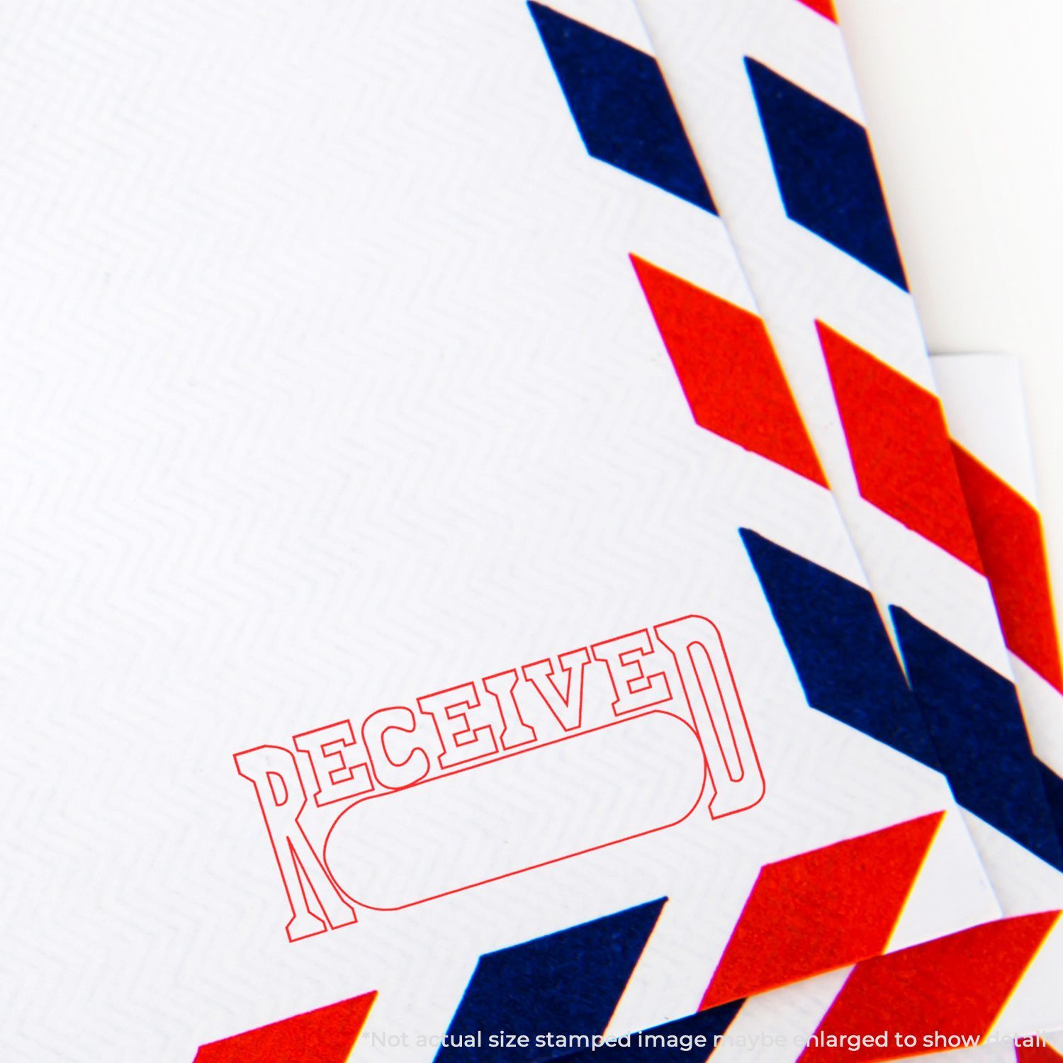 Close-up of a red and blue airmail envelope with a bold RECEIVED stamp and geometric envelope pattern.