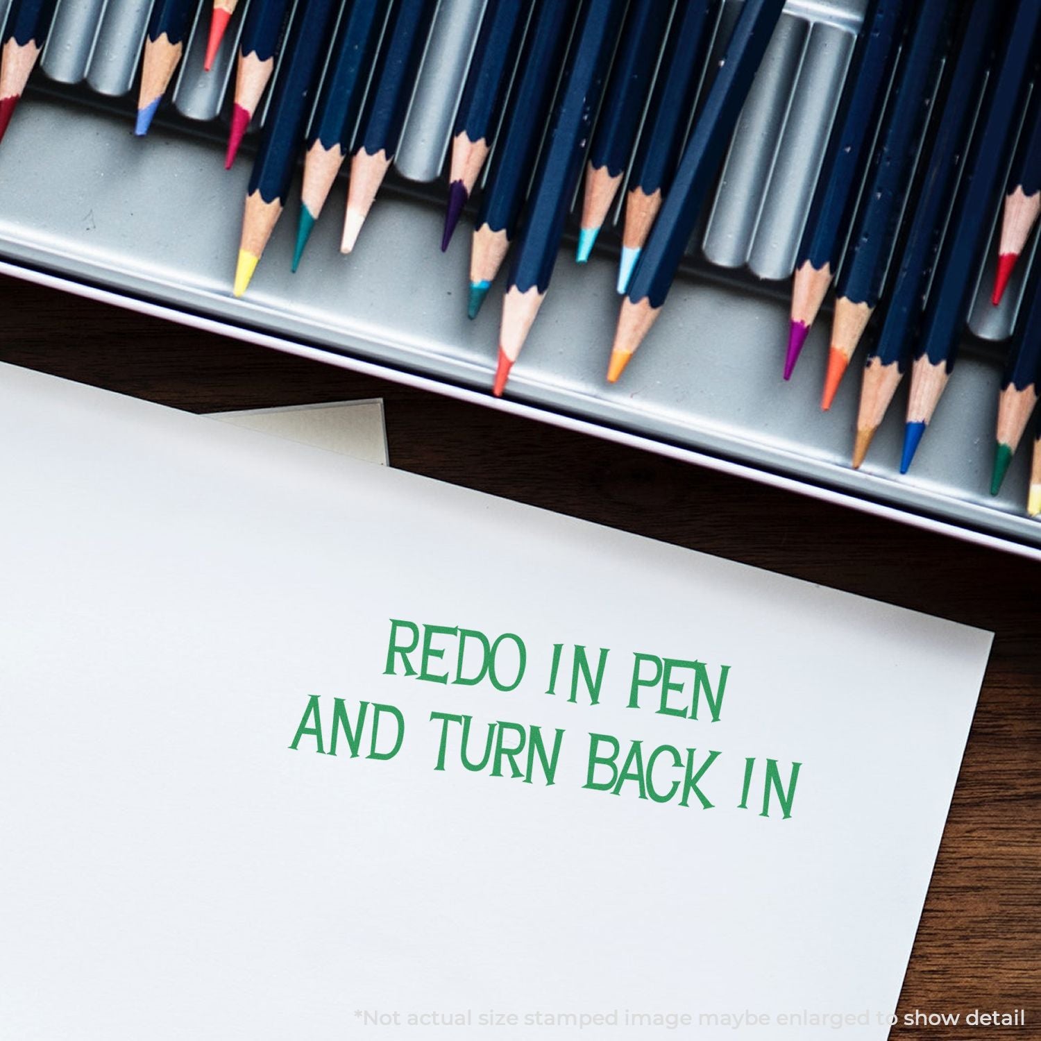 Colored pencils and a paper note reading Redo in pen and turn back in on a desk, school assignment correction reminder