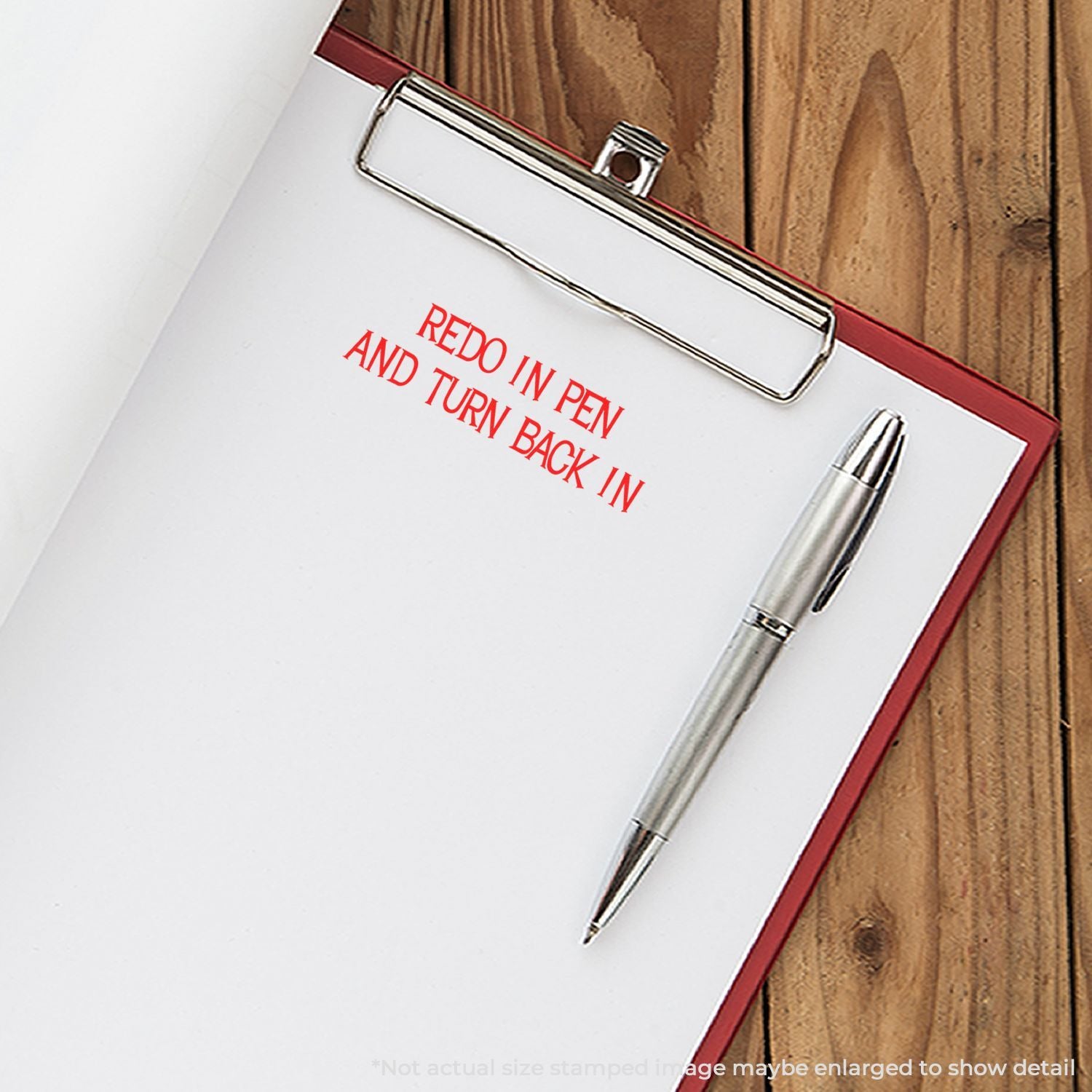 Clipboard with pen and red Redo in pen and turn back in text on paper over wooden desk