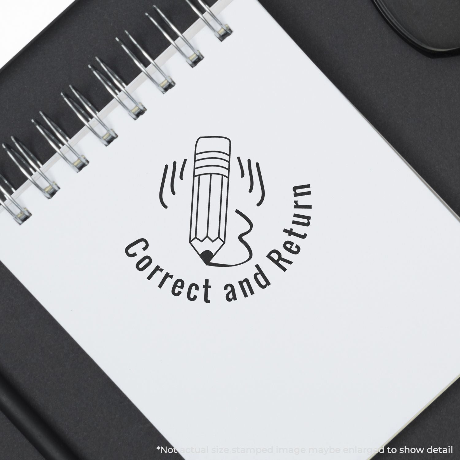 Close-up of spiral notebook with Correct and Return stamp, pencil icon, and office proofreading concept.